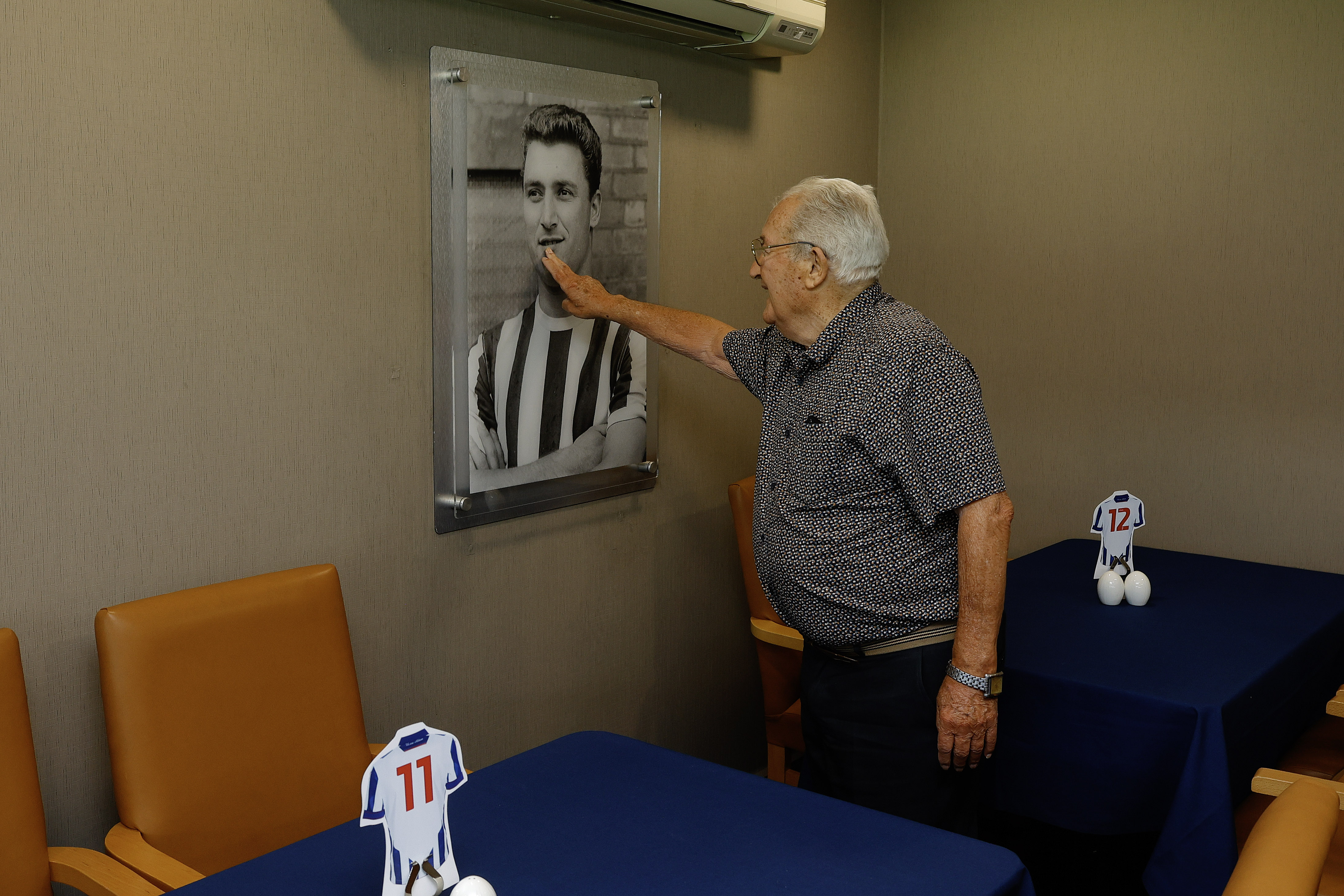 Graham Williams looking at a picture on the wall at The Hawthorns 