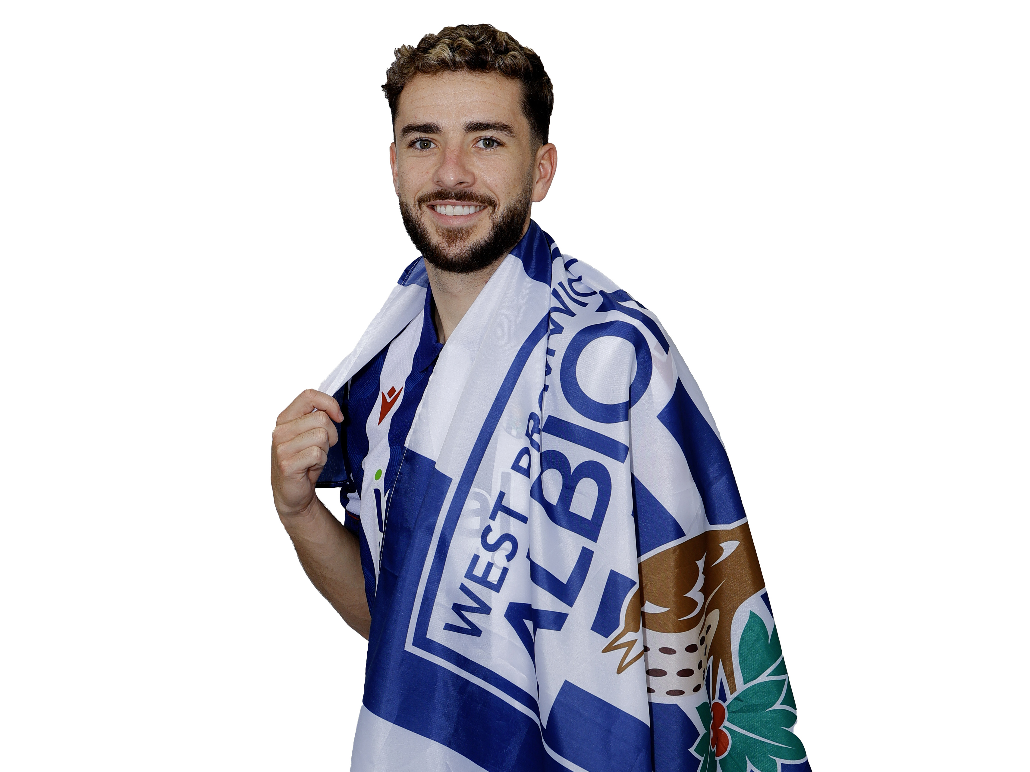 Mikey Johnston smiling at the camera while wrapped in a WBA flag