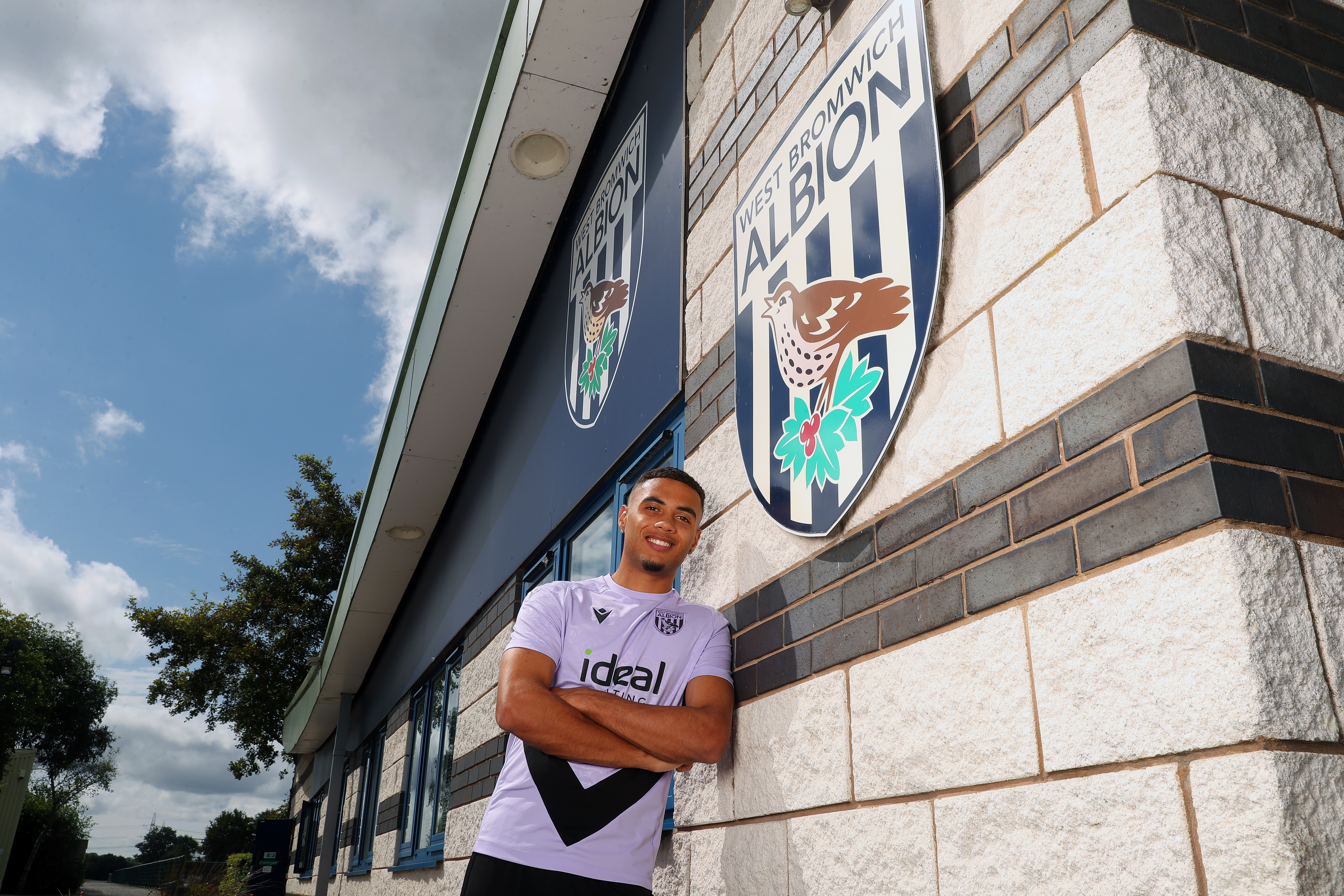 Lewis Dobbin smiling at the camera while stood outside the training ground 