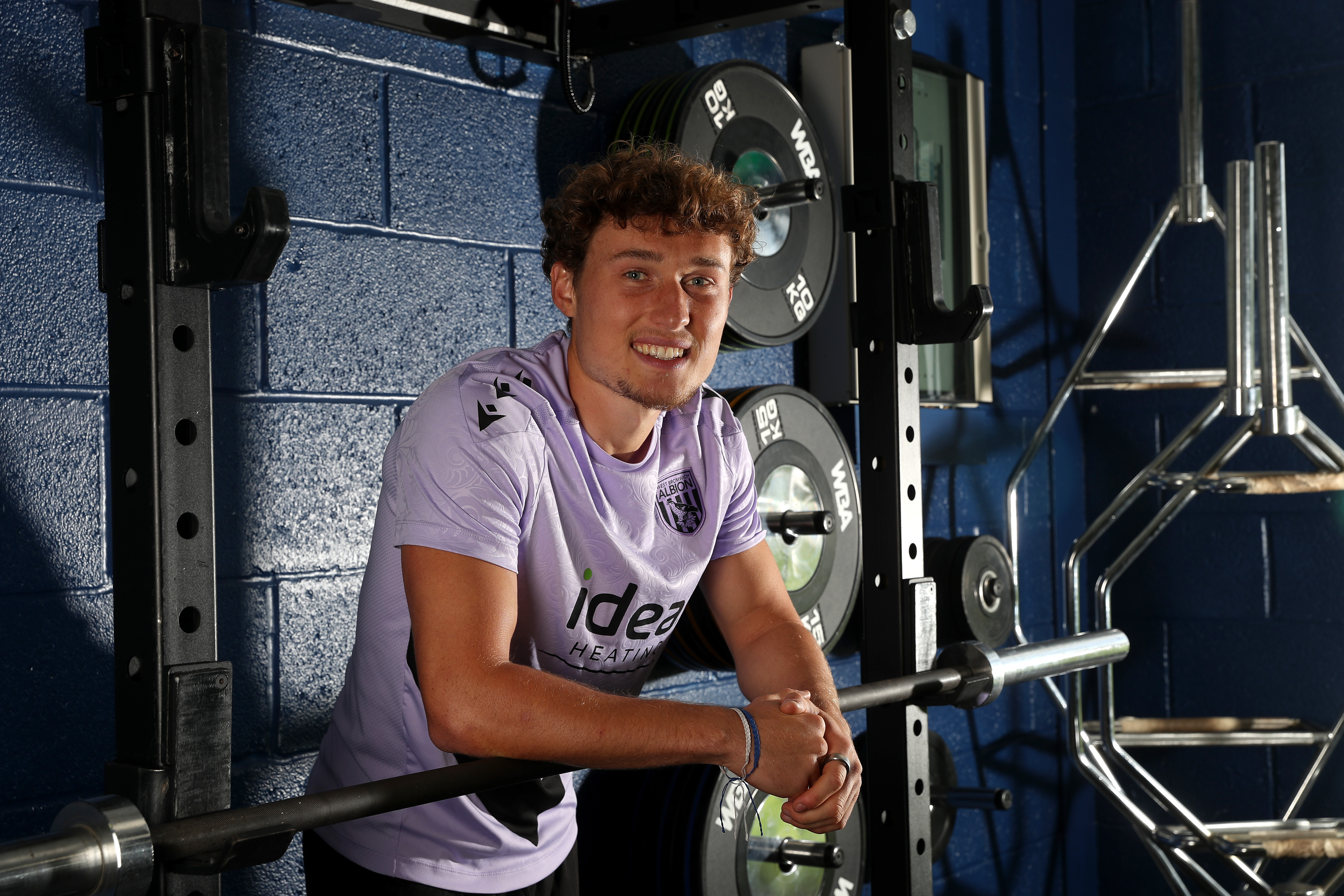 Callum Styles smiling at the camera while stood in the gym