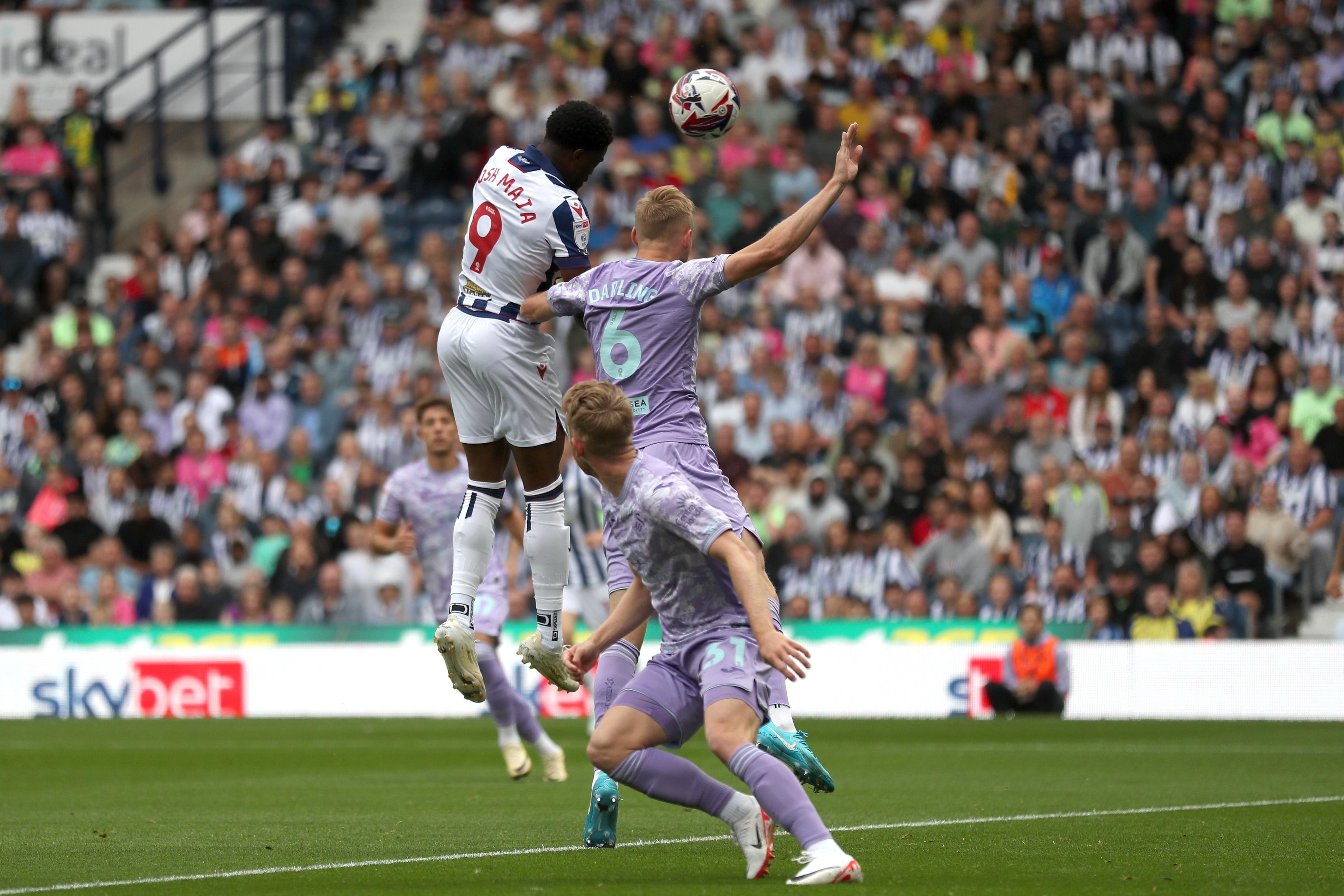 Josh Maja jumps to try and win a header against Swansea 