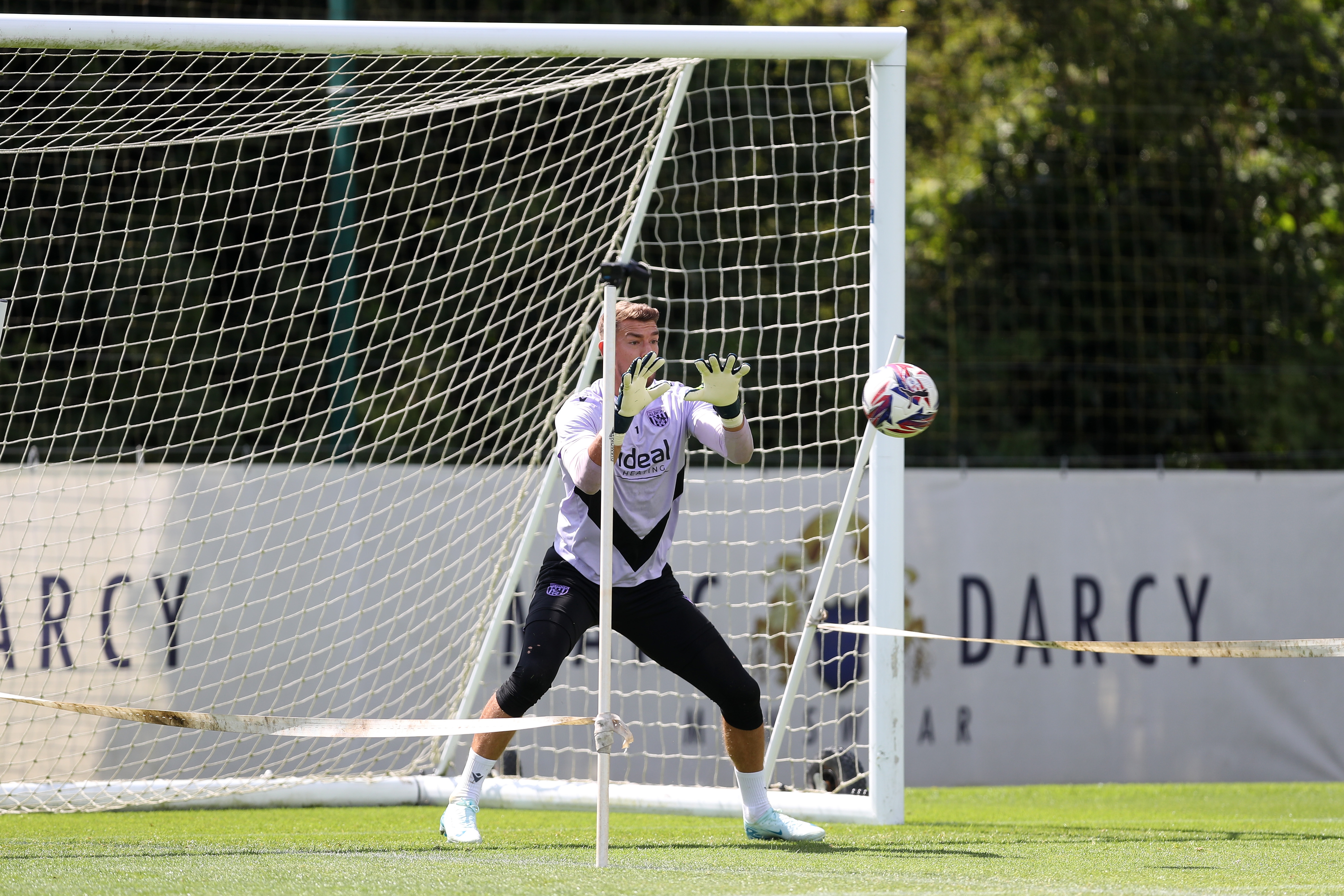 Alex Palmer catching a ball during a training session 