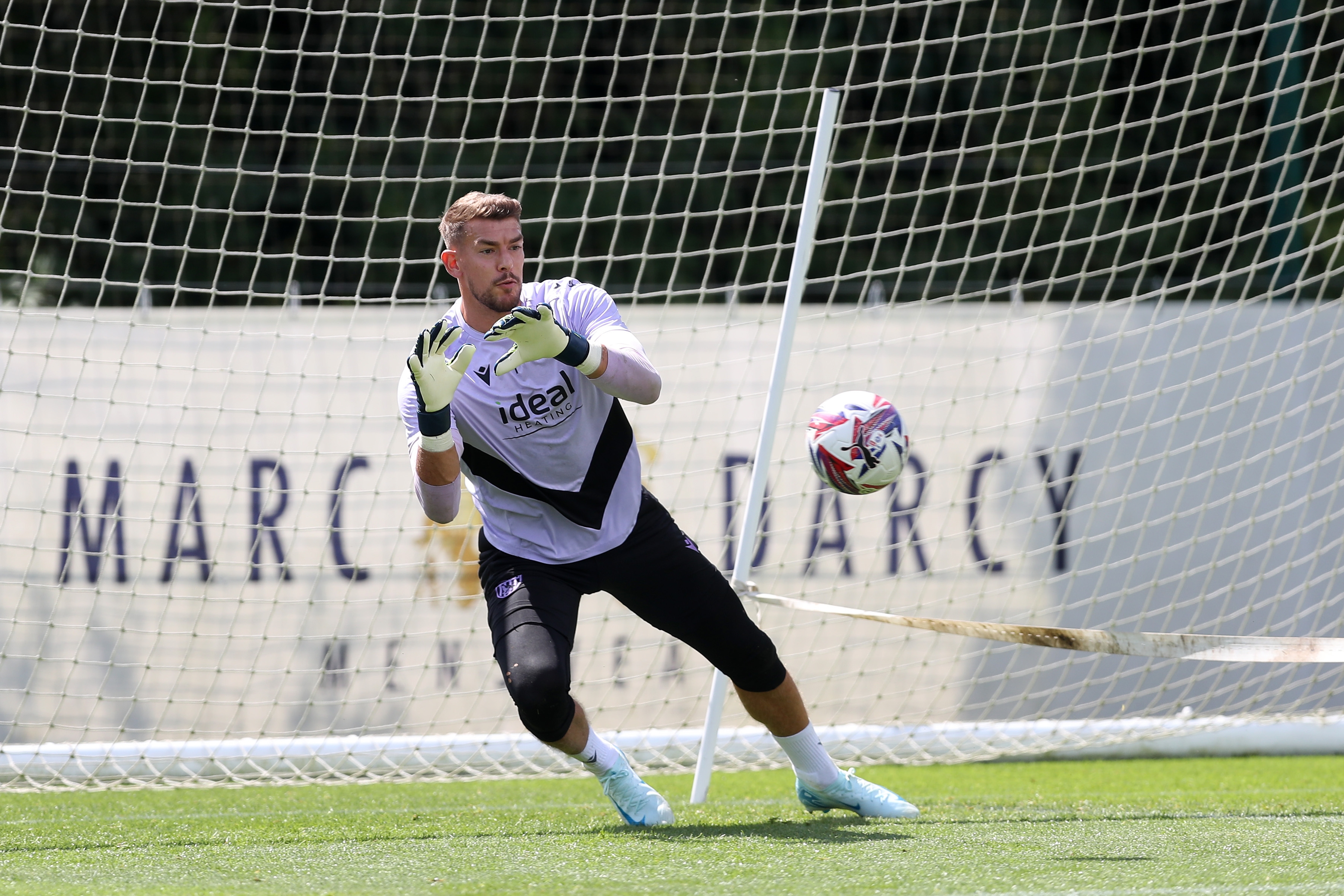 Alex Palmer diving to catch a ball during training 