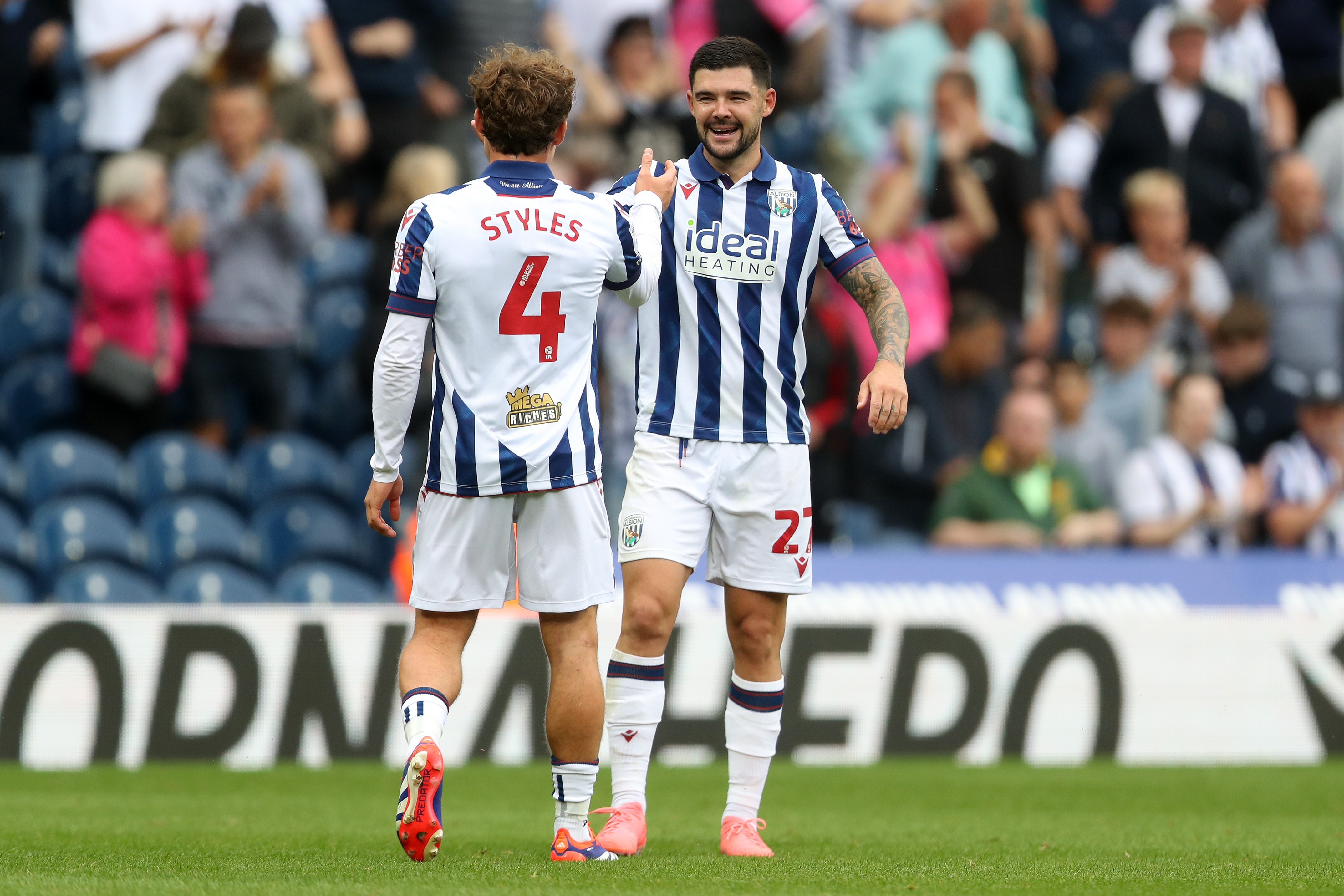 Alex Mowatt and Callum Styles embrace after beating Swansea 