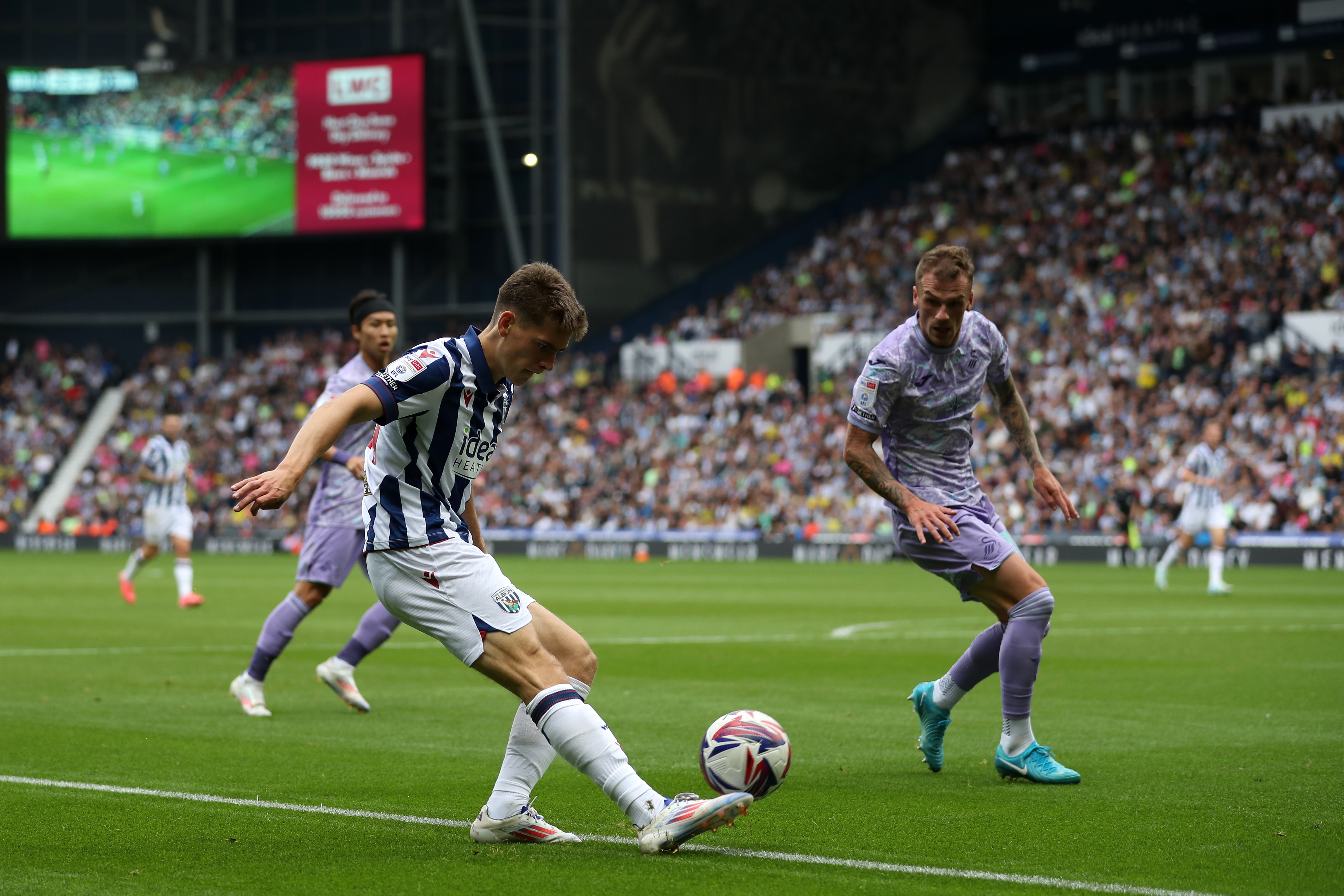 Tom Fellows crossing the ball against Swansea 