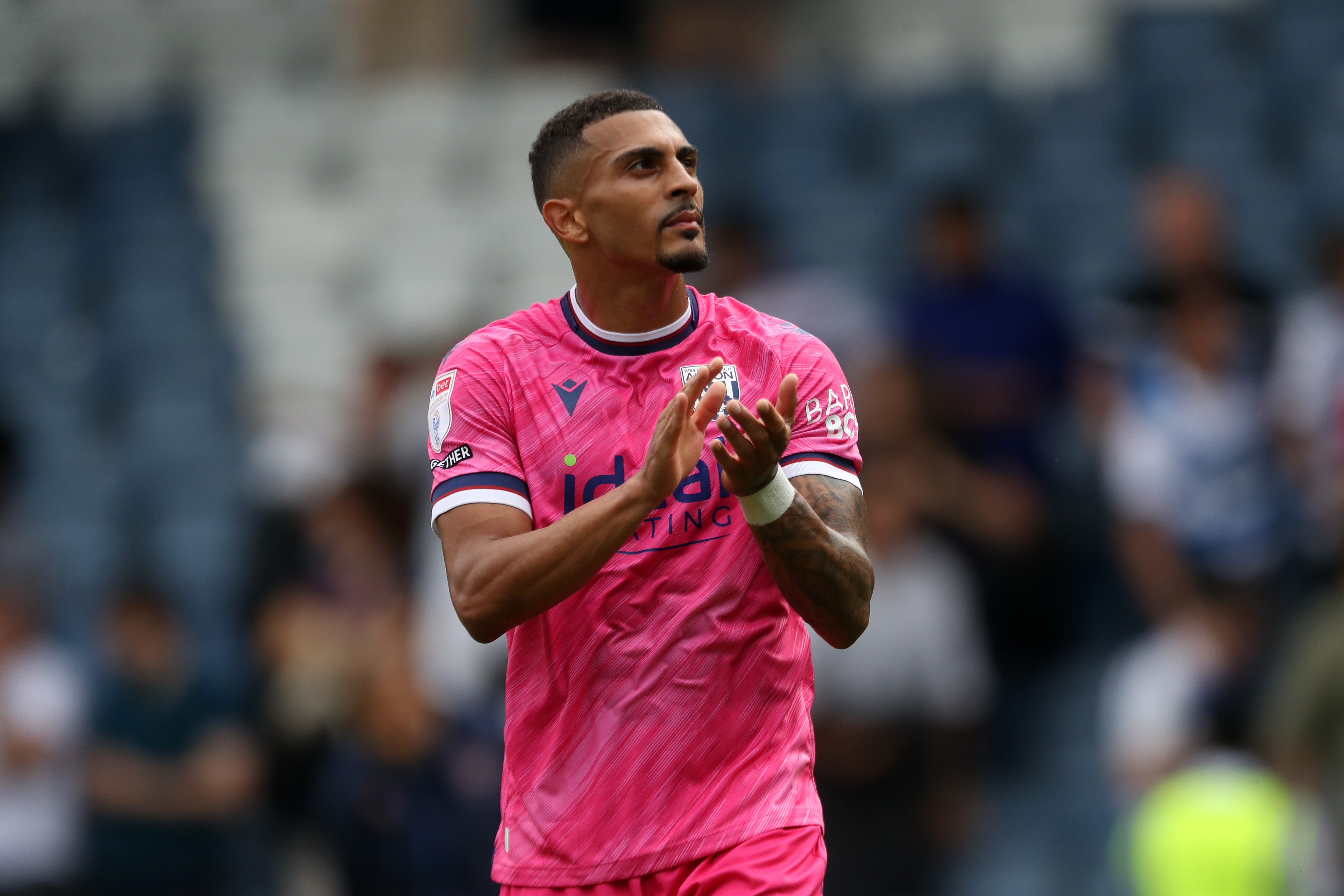 Karlan Grant applauding Albion fans at QPR 