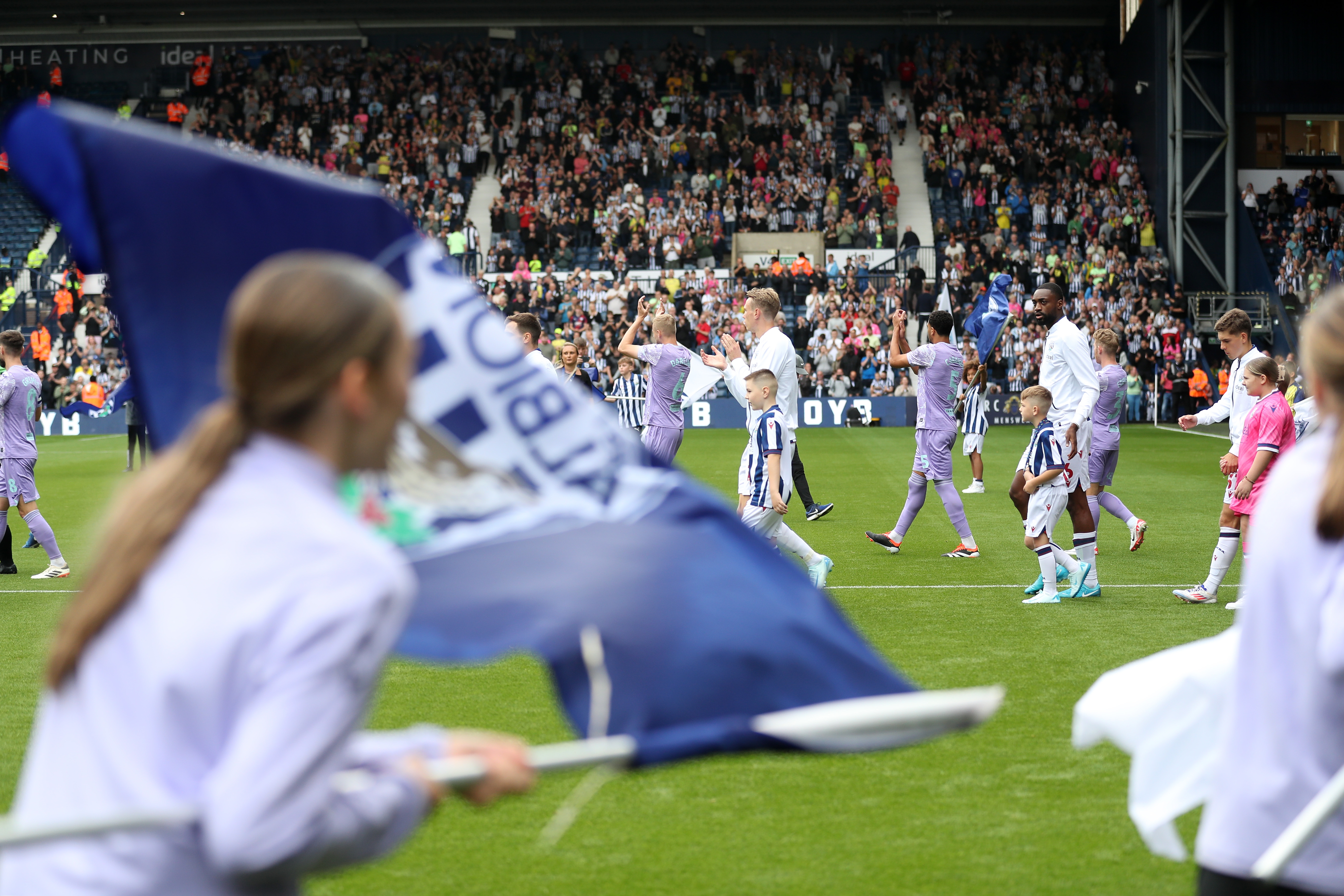 Albion players walk out at The Hawthorns with flags around them