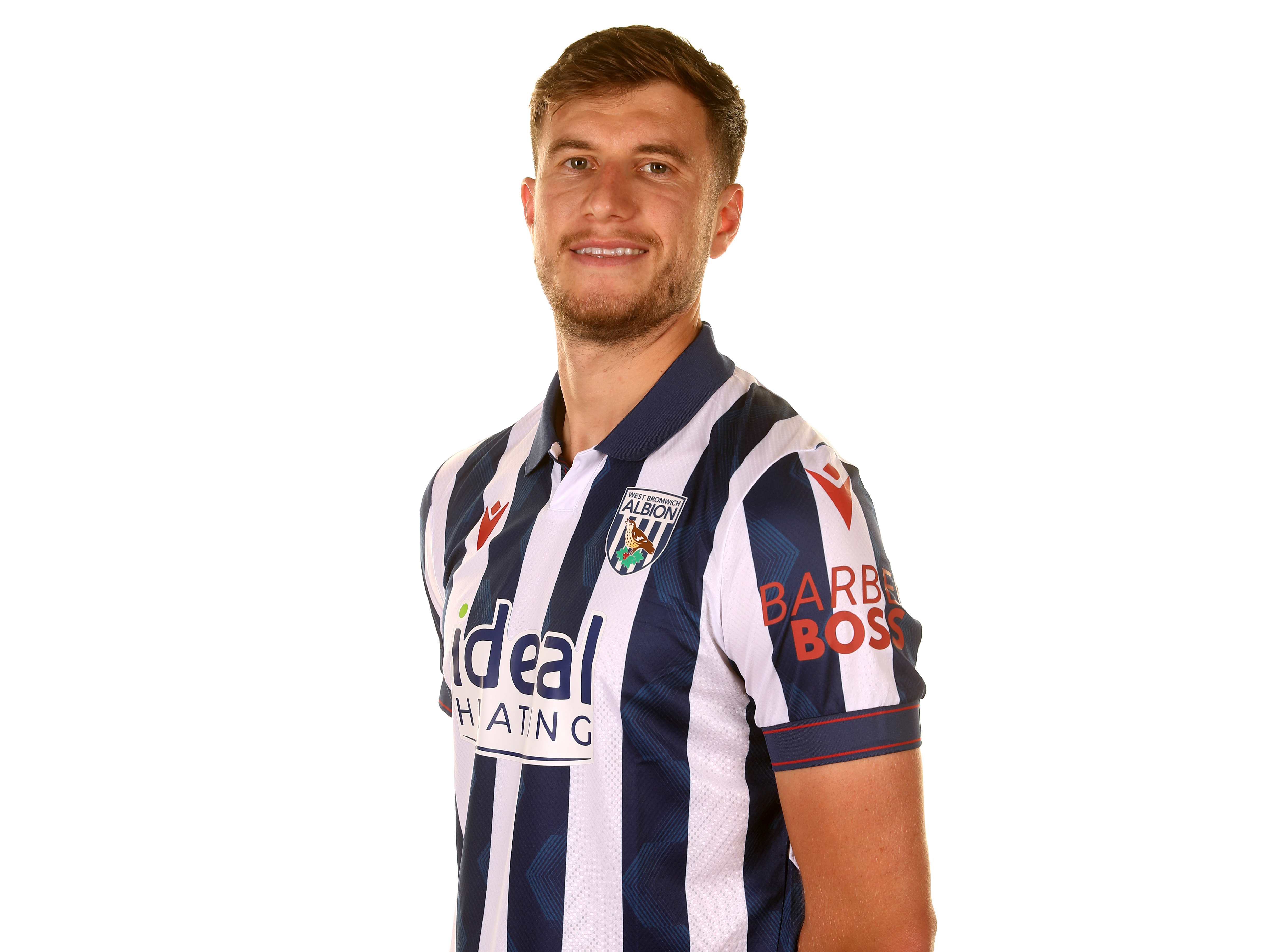 Paddy McNair smiling at the camera while wearing a home shirt 