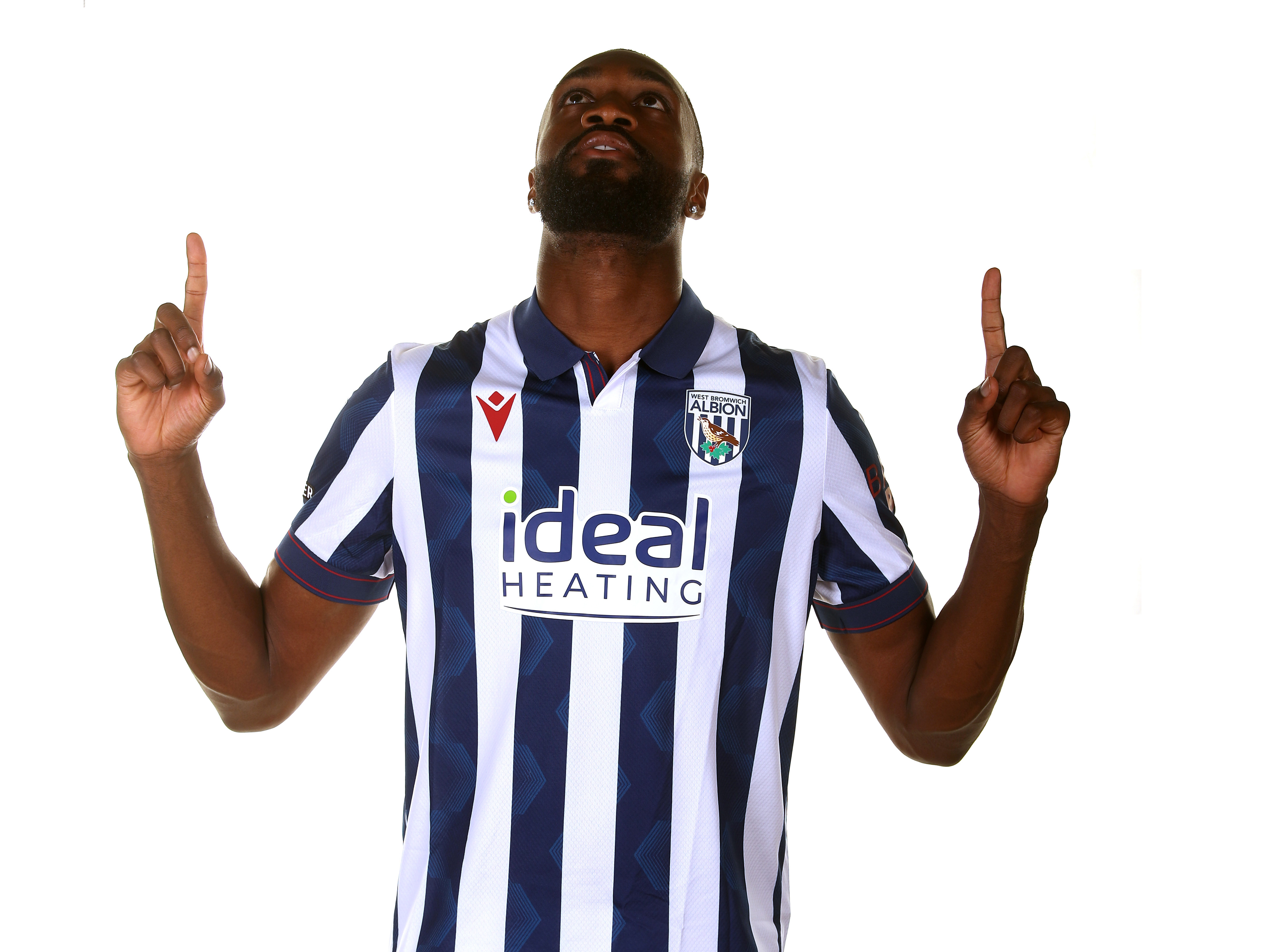 Semi Ajayi in a home shirt pointing to the sky 