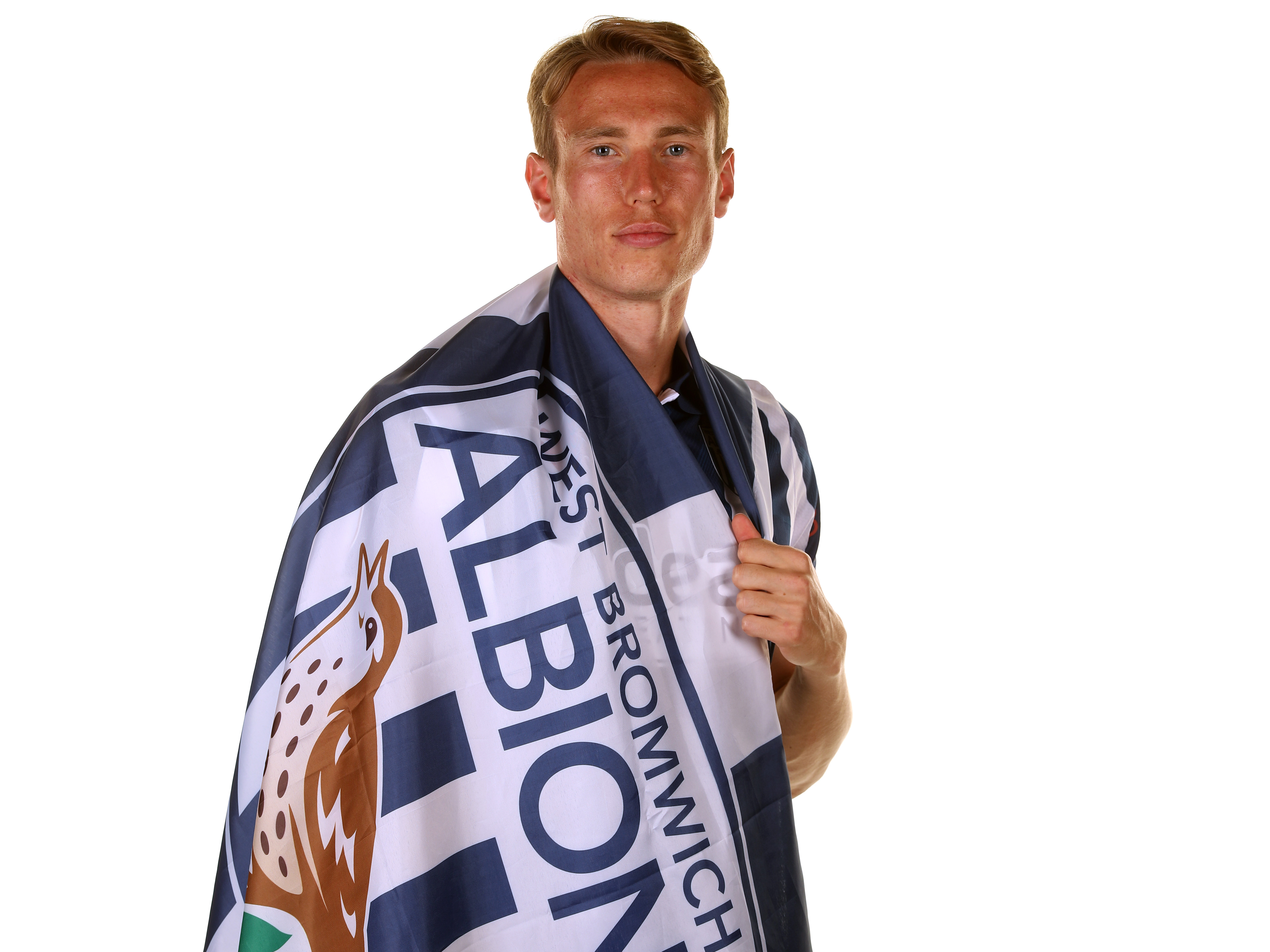 Torbjørn Heggem wrapped in a WBA flag in a home shirt looking at the camera 