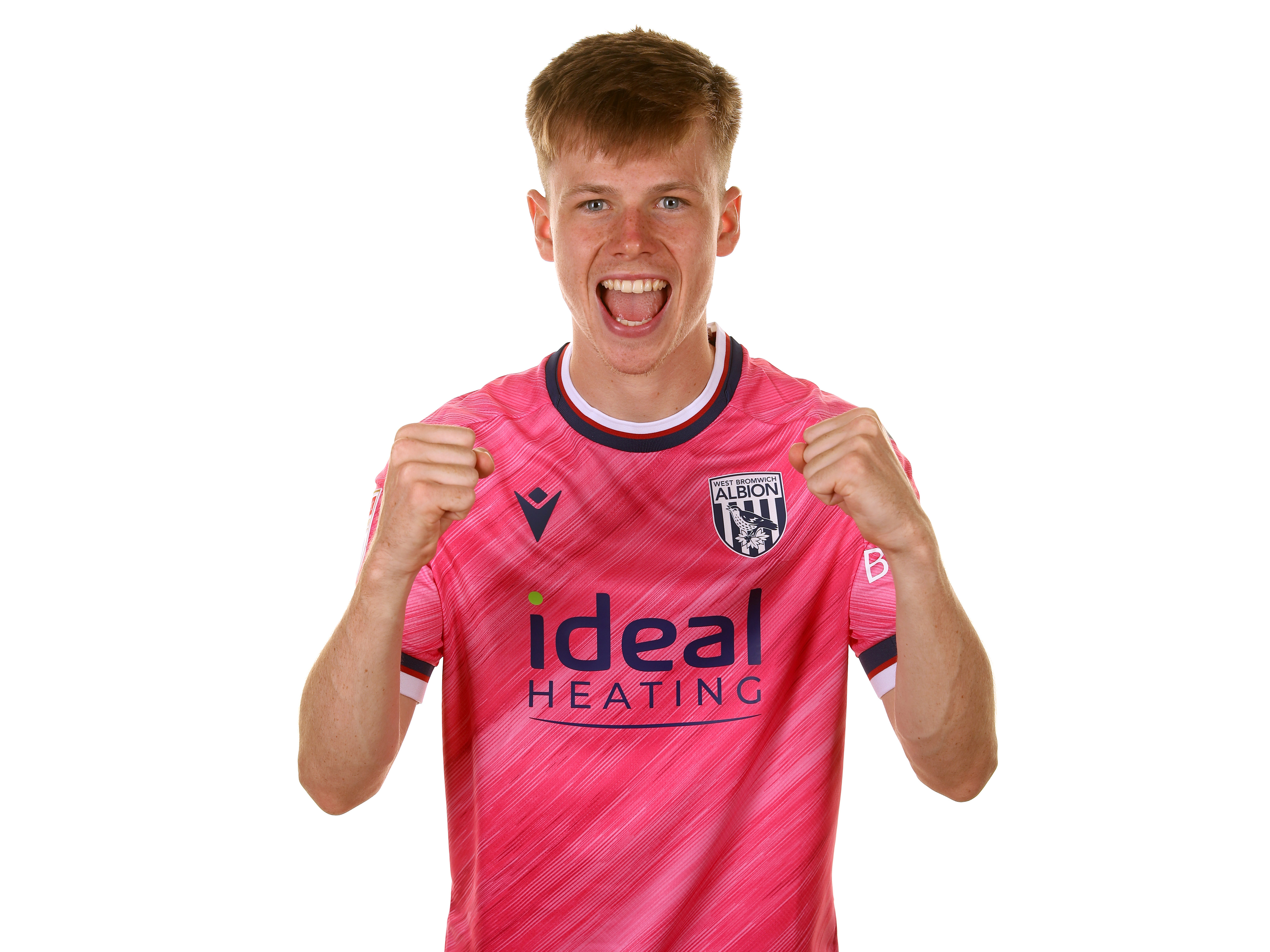 Fenton Heard celebrating at the camera with his fists clenched while wearing the pink shirt 