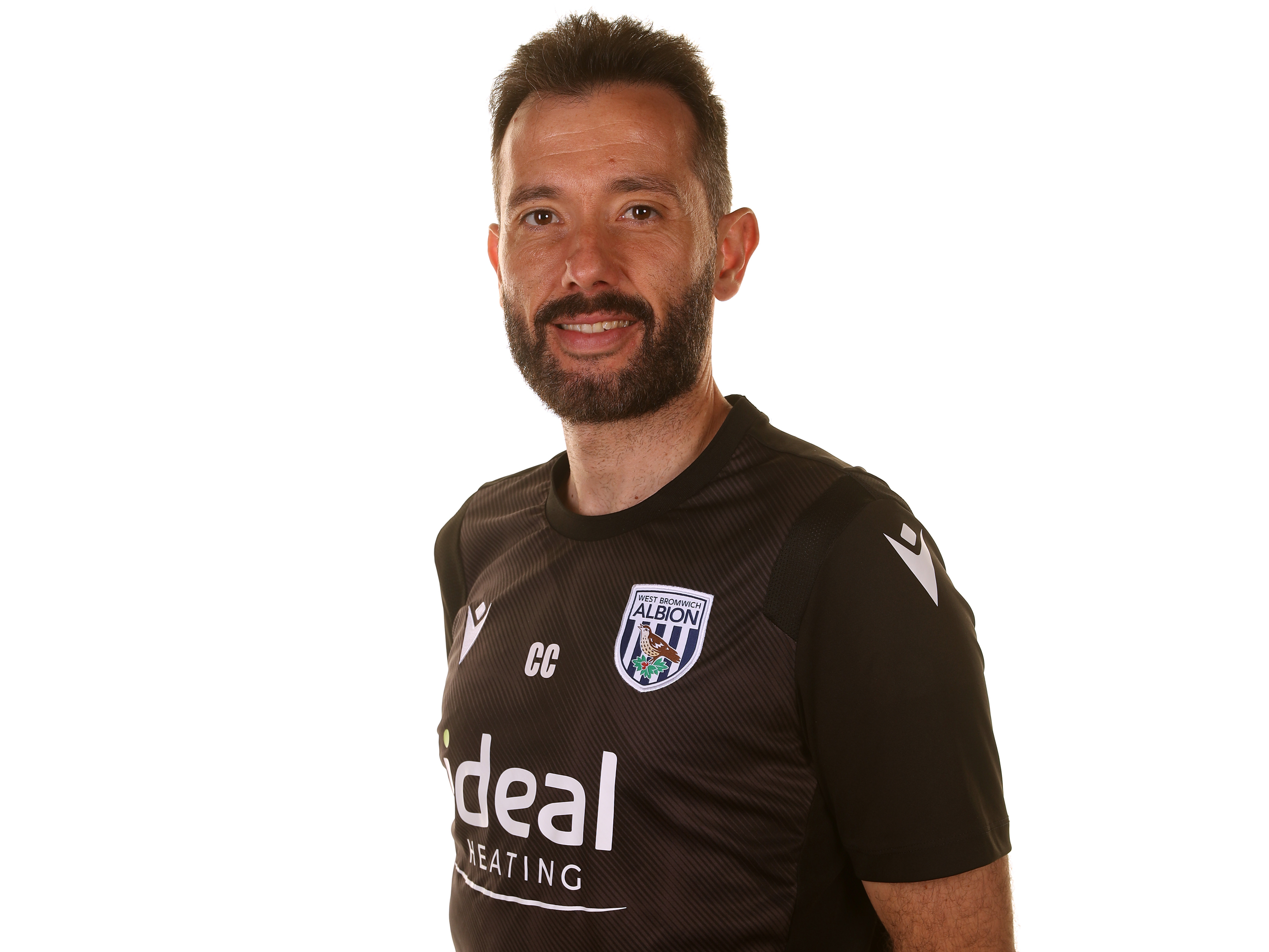 Albion head coach Carlos Corberán smiling at the camera 