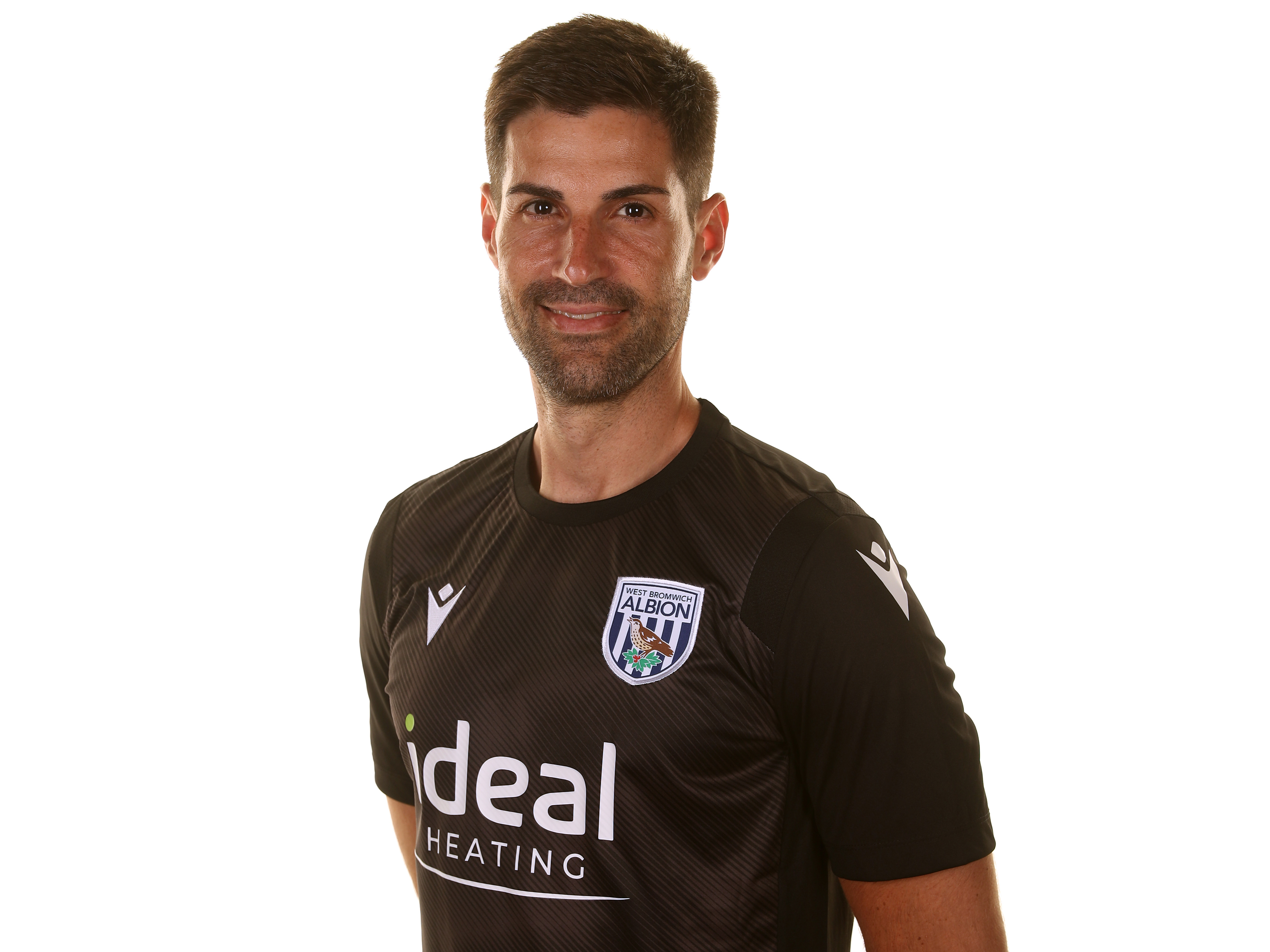 Albion first team assistant coach Jorge Alarcon smiling at the camera 