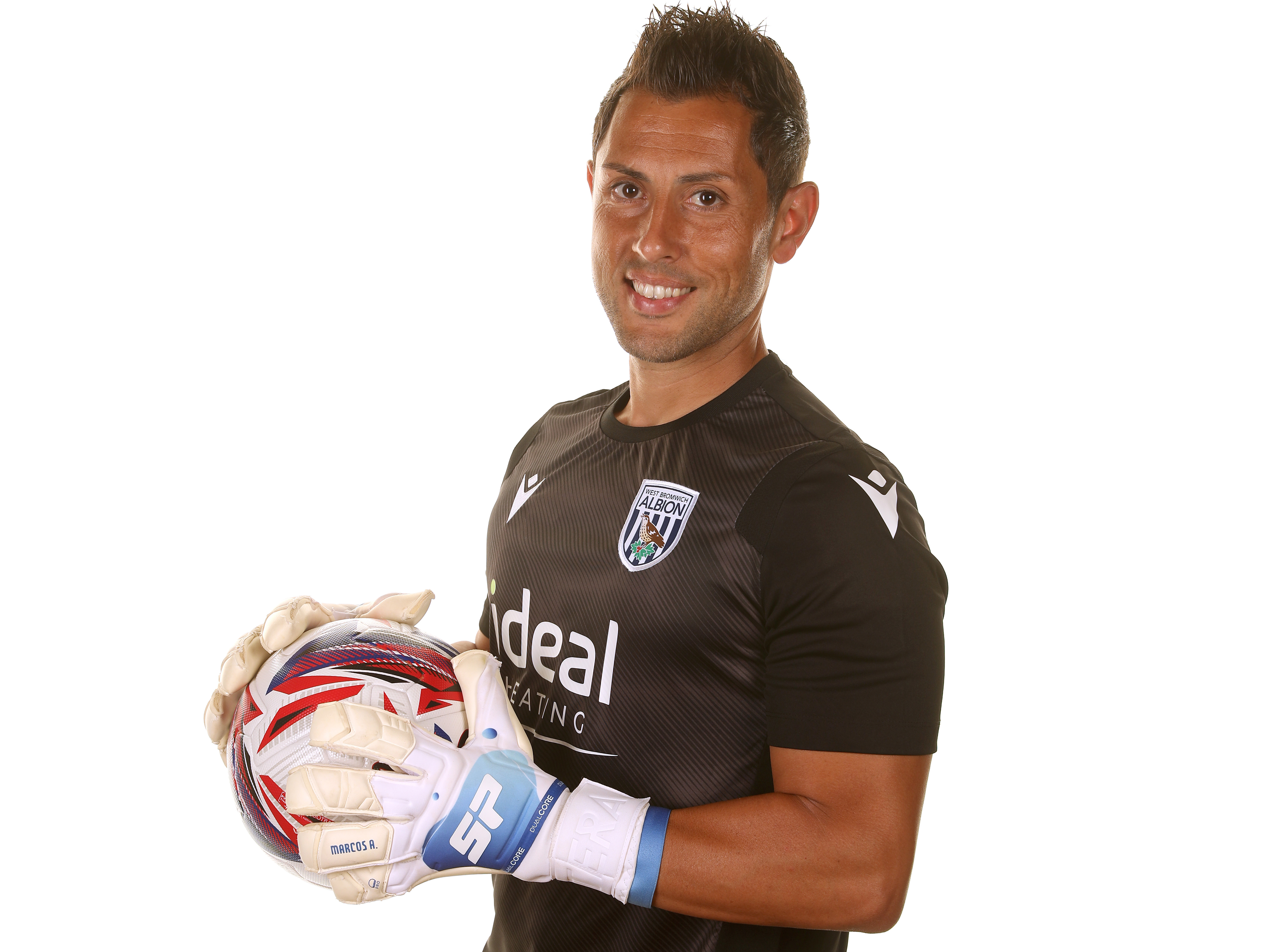 Albion goalkeeping coach Marcos Abad smiling at the camera 