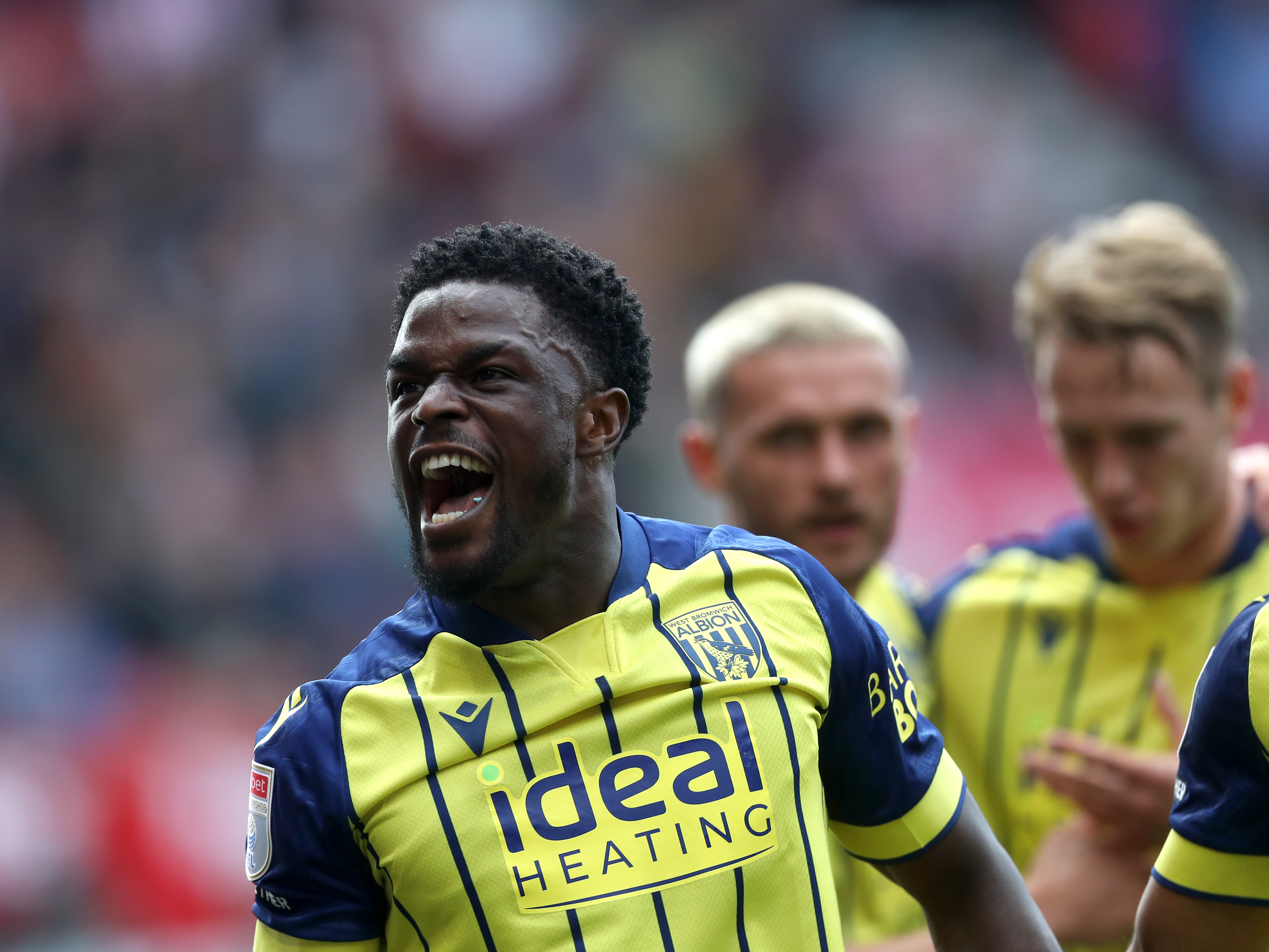 A photo of Albion players in the yellow and blue 2024/25 away kit against Stoke City