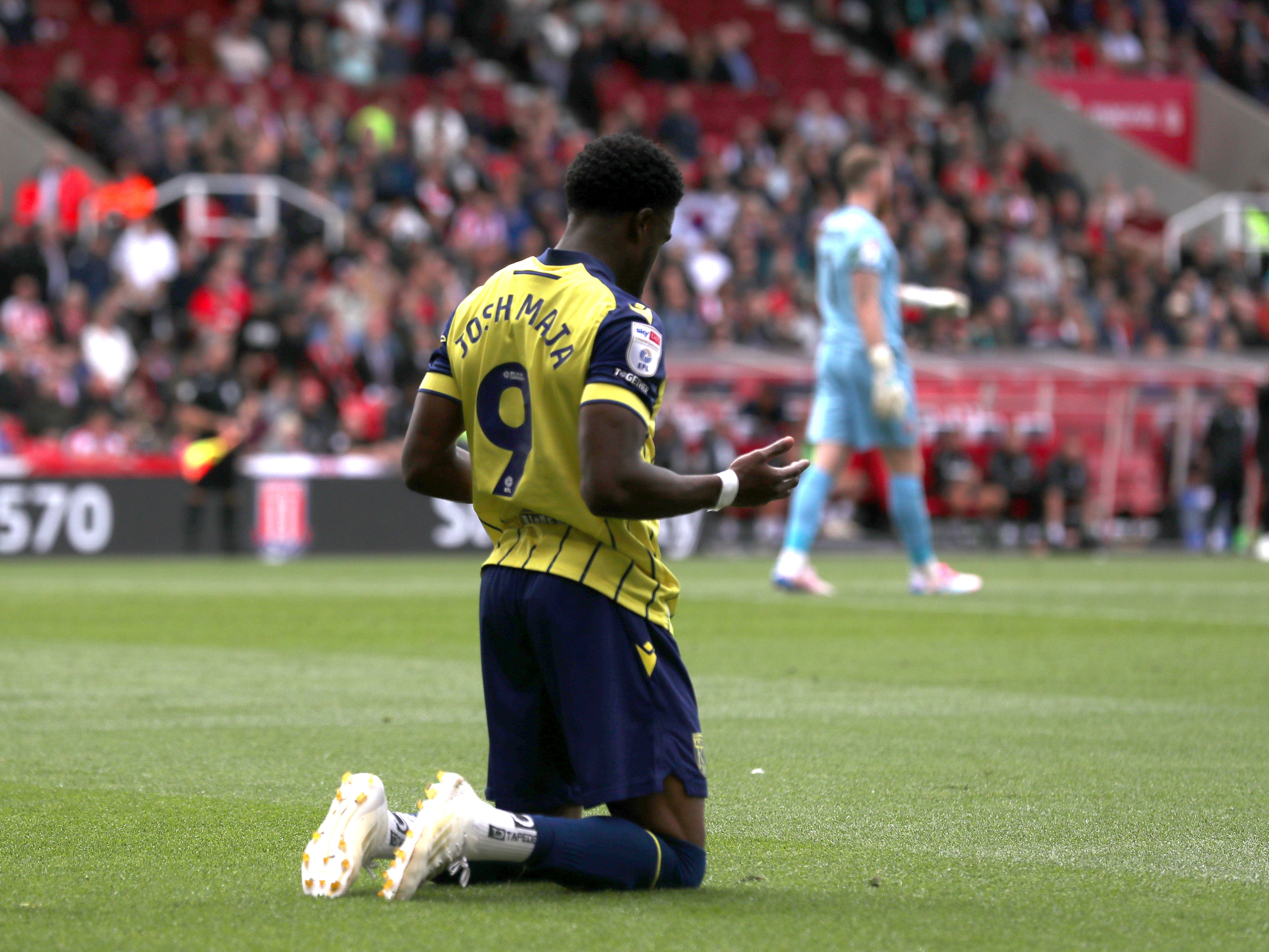 A photo of Albion players in the yellow and blue 2024/25 away kit against Stoke City