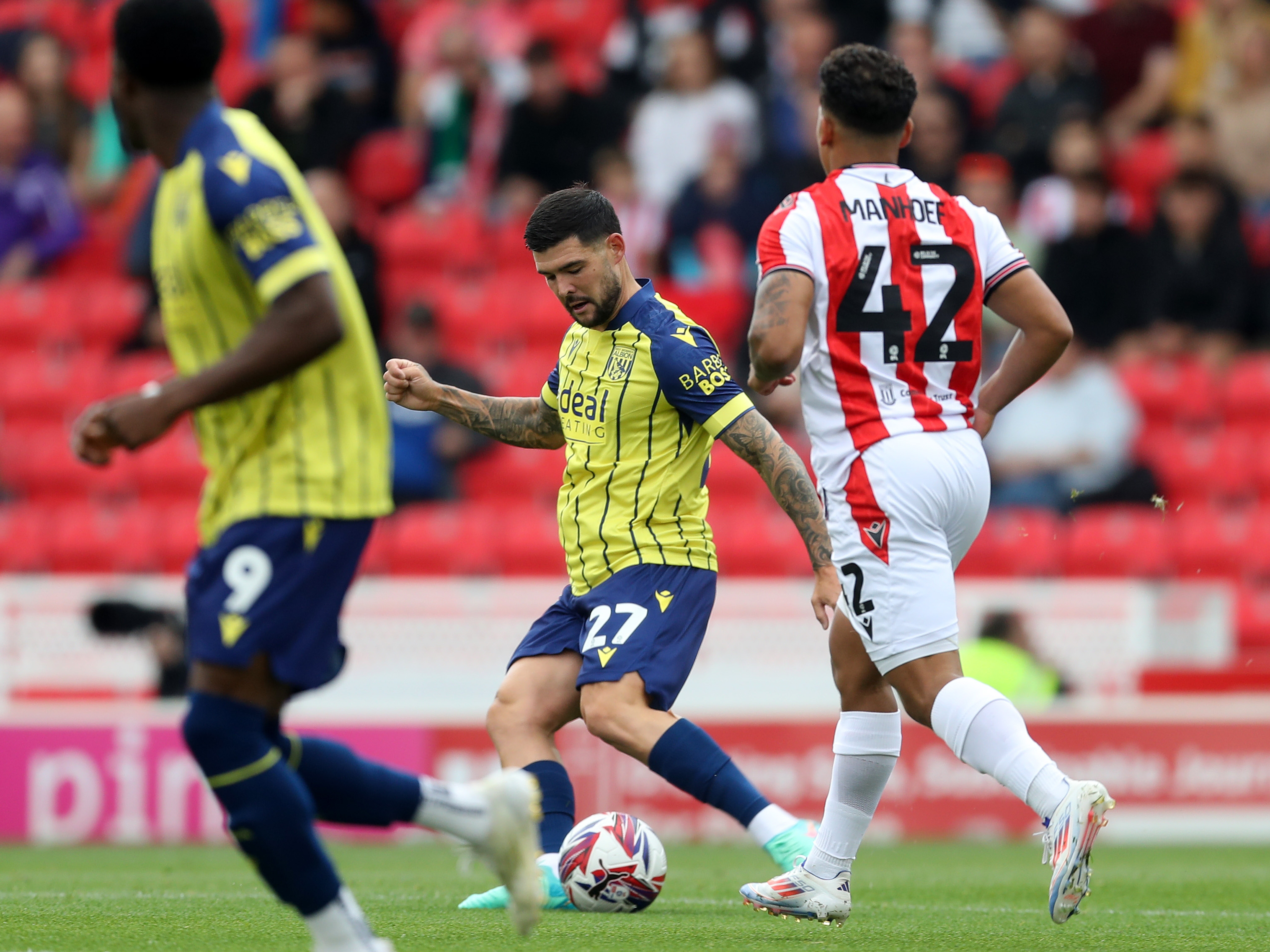 A photo of Albion players in the yellow and blue 2024/25 away kit against Stoke City