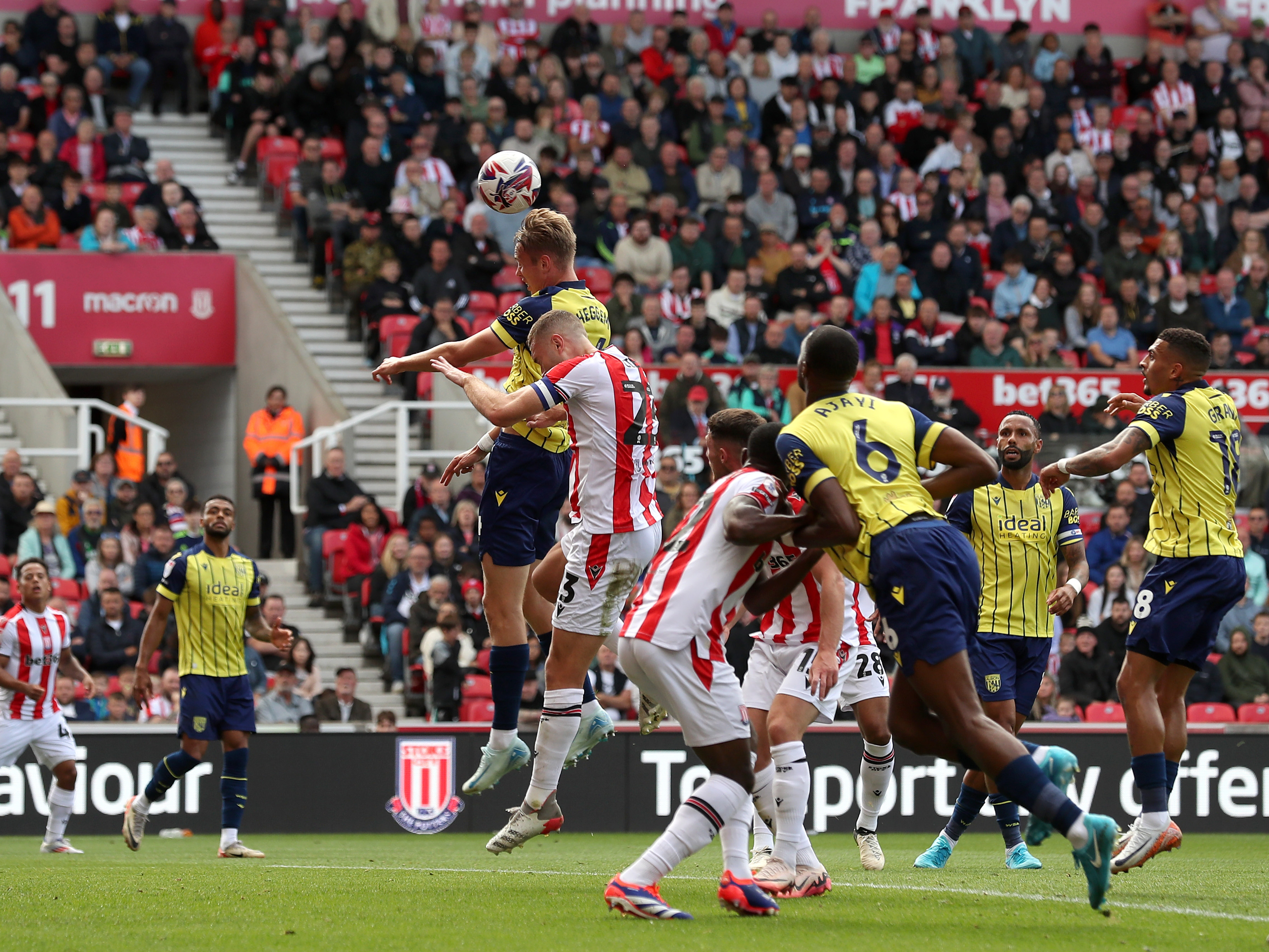 A photo of Albion players in the yellow and blue 2024/25 away kit against Stoke City