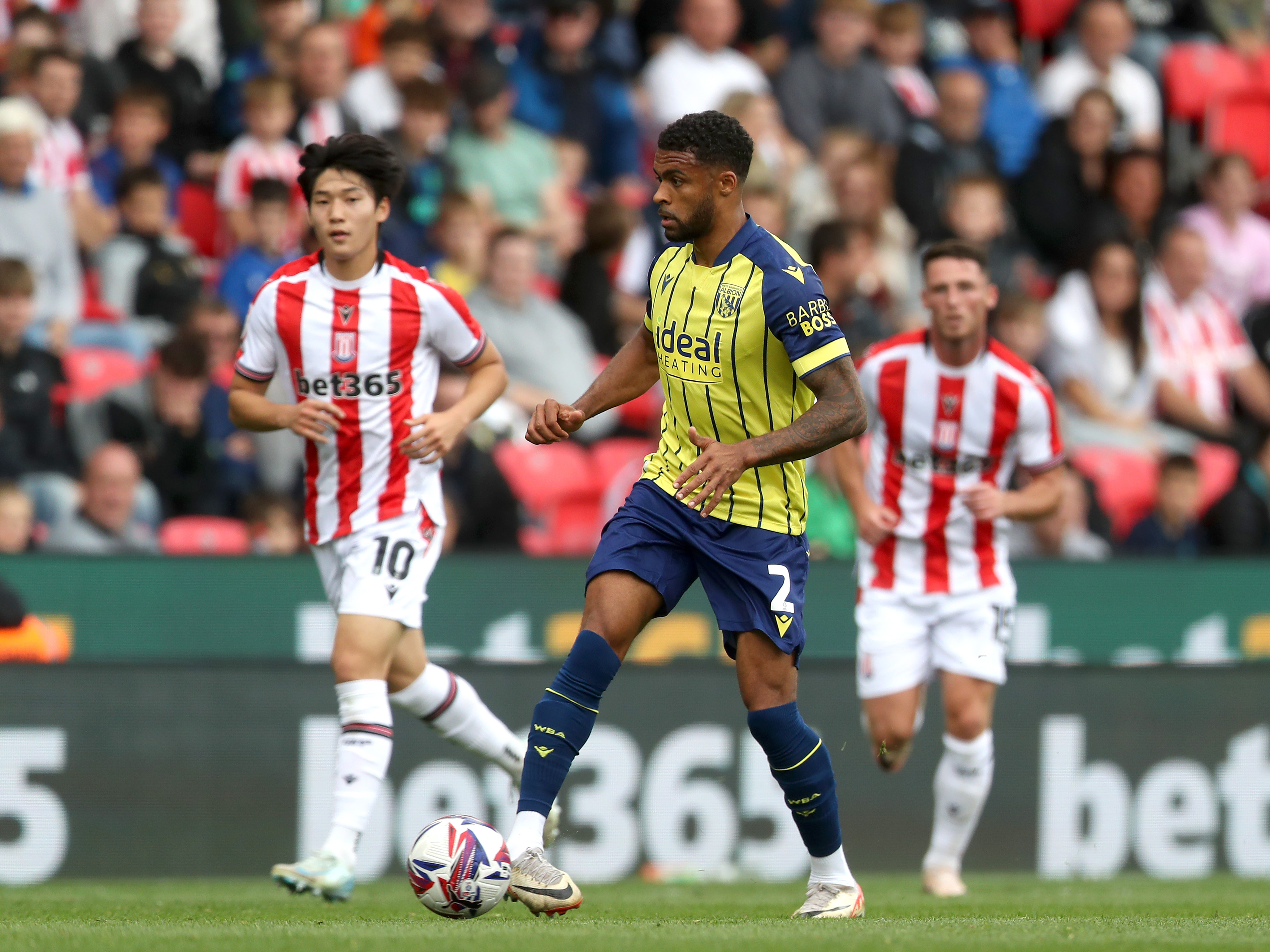 A photo of Albion players in the yellow and blue 2024/25 away kit against Stoke City