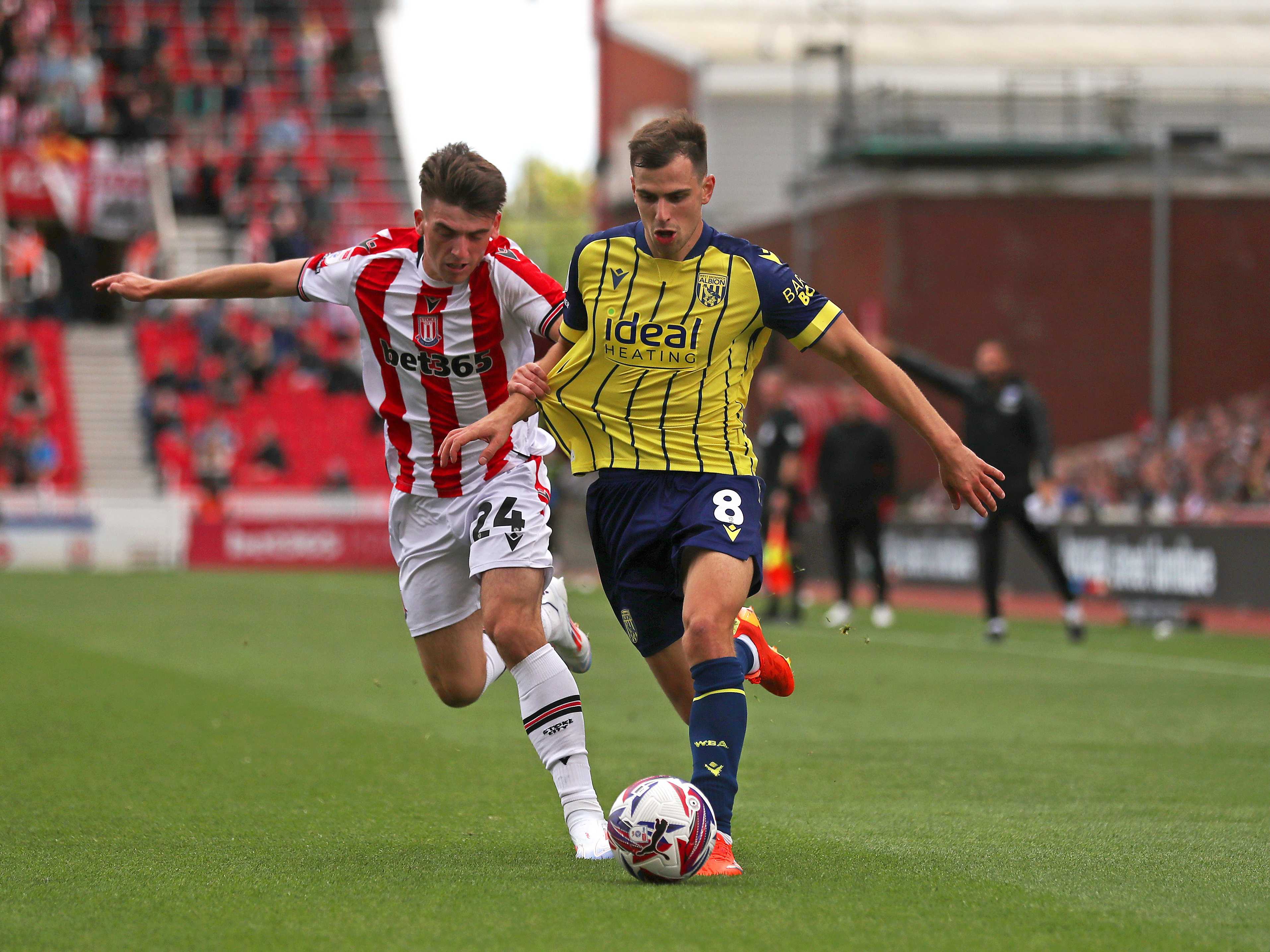 A photo of Albion players in the yellow and blue 2024/25 away kit against Stoke City