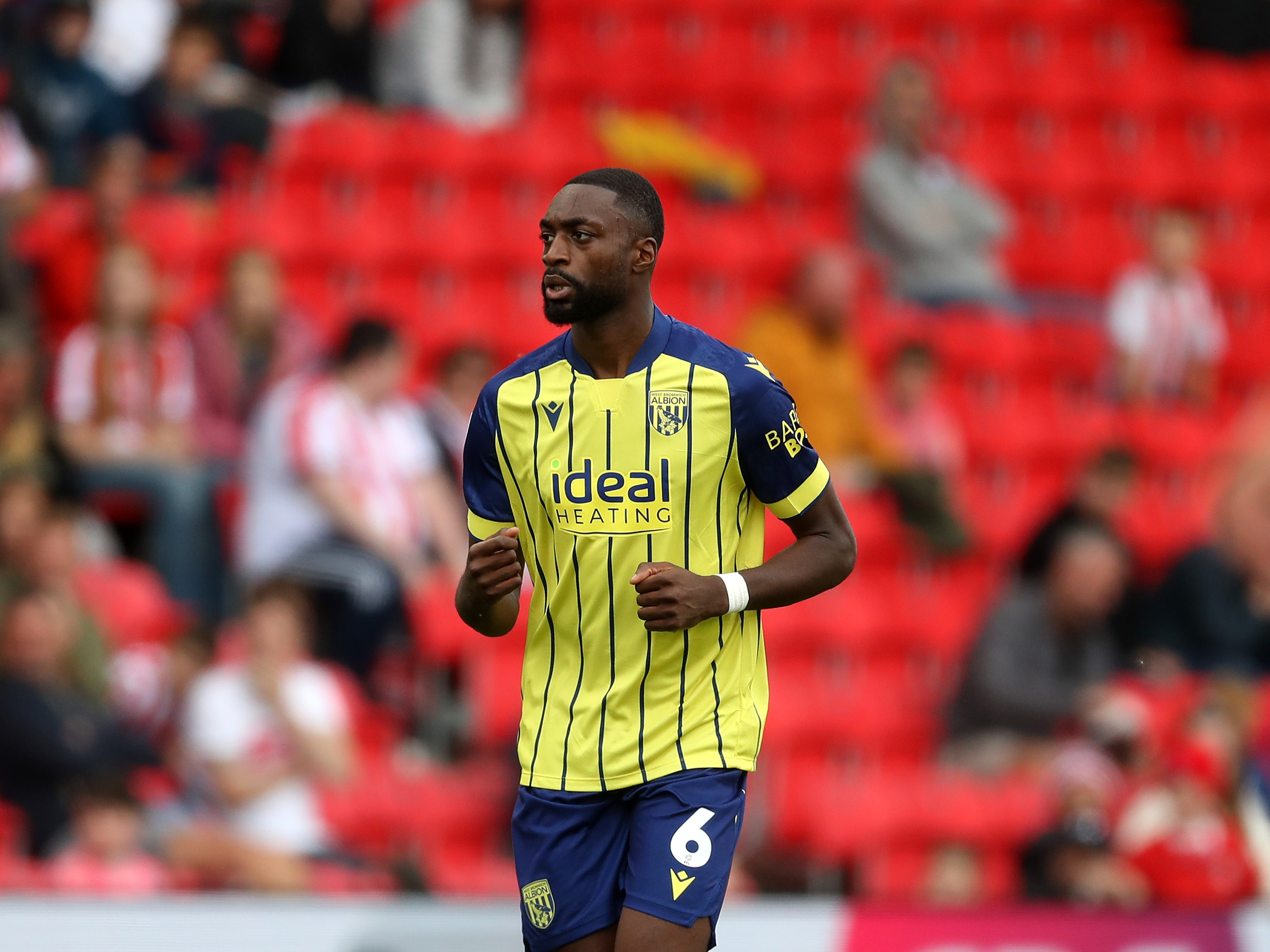 A photo of Albion players in the yellow and blue 2024/25 away kit against Stoke City