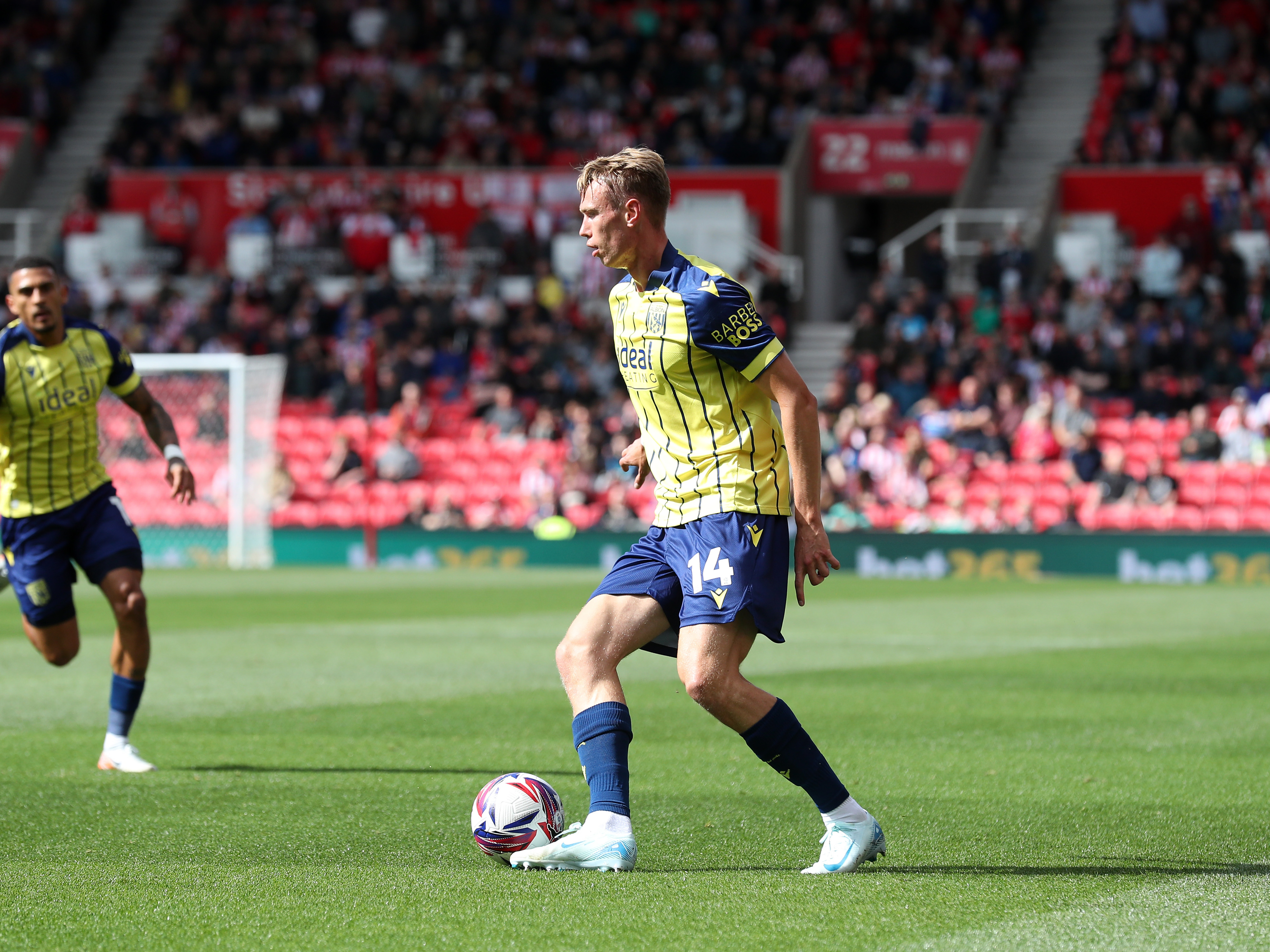 A photo of Albion players in the yellow and blue 2024/25 away kit against Stoke City