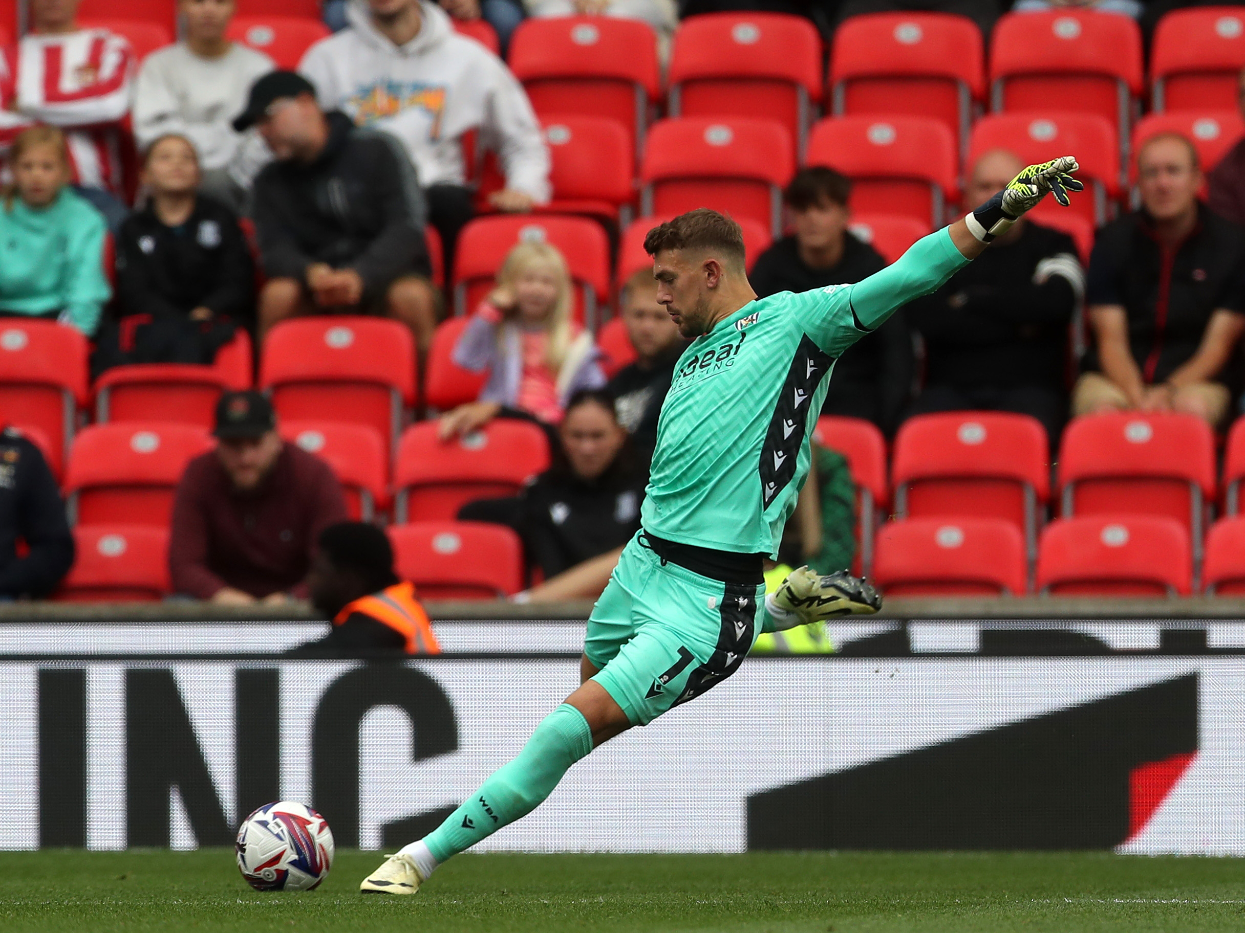 A photo of Albion players in the yellow and blue 2024/25 away kit against Stoke City