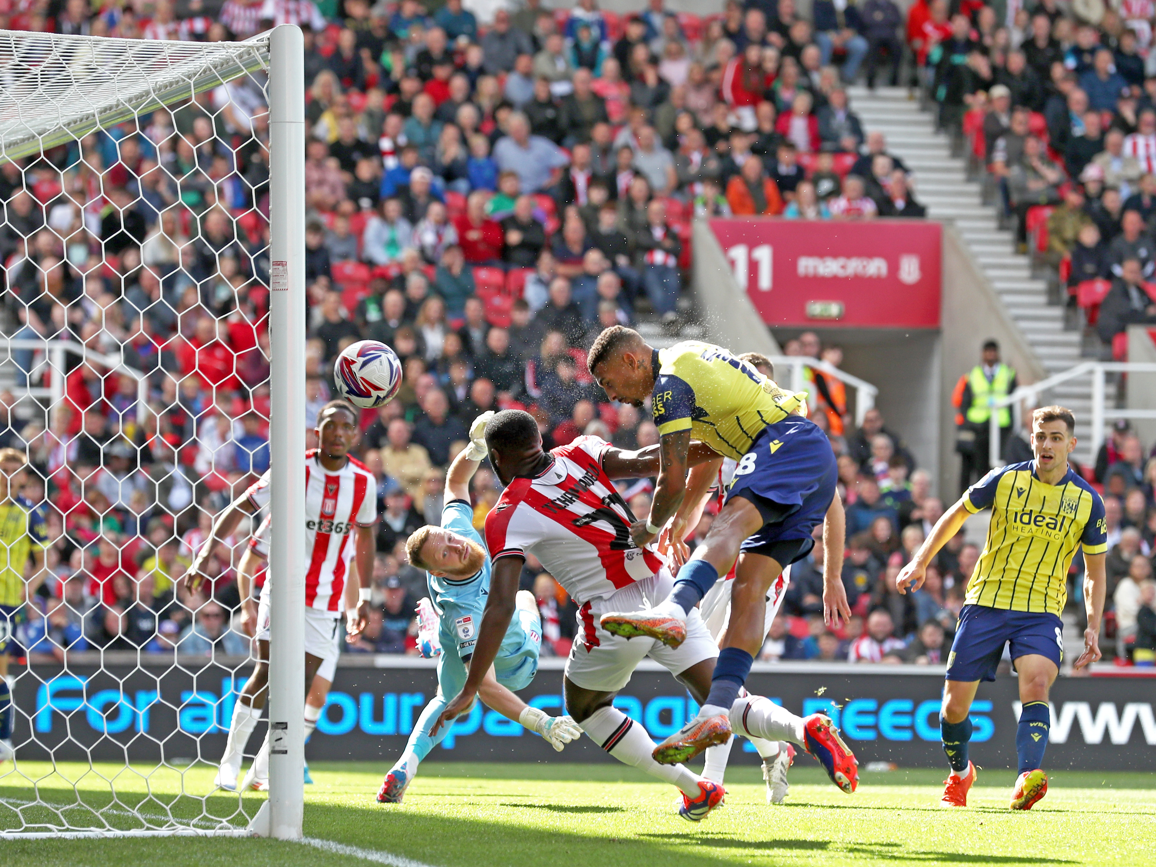 A photo of Albion players in the yellow and blue 2024/25 away kit against Stoke City