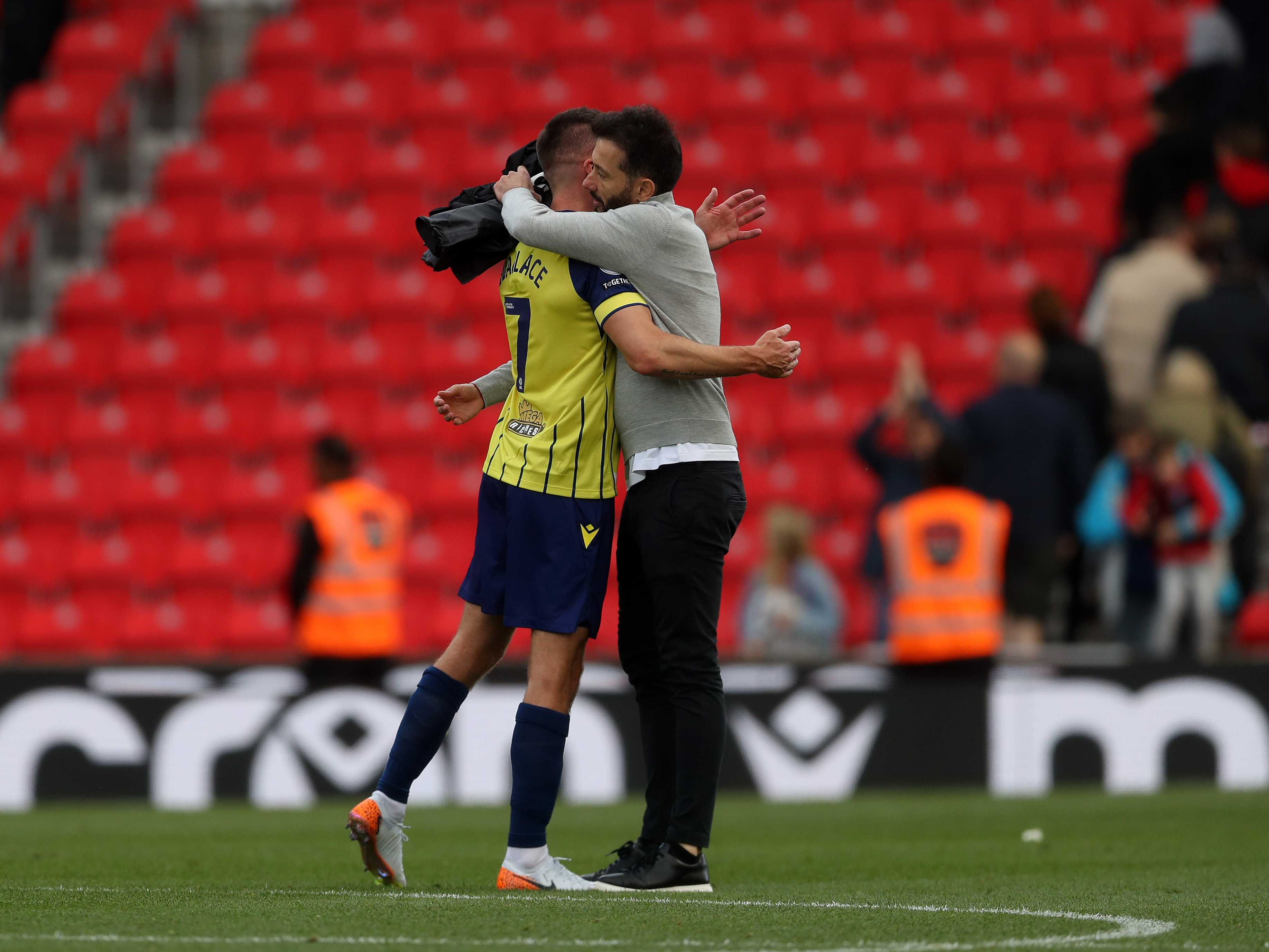 A photo of Jed Wallace and Carlos Corberán embracing at Stoke City