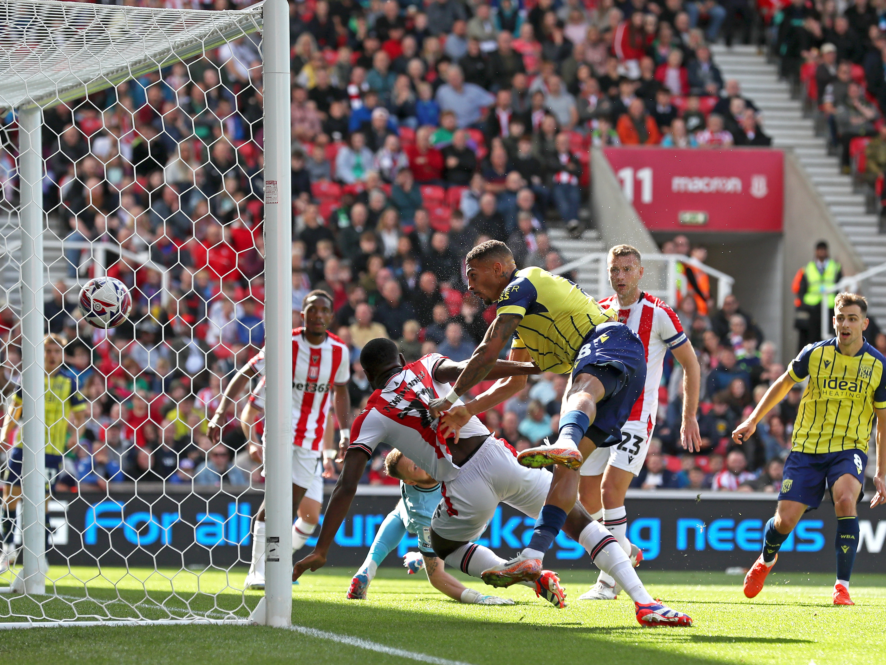 A photo of Albion players in the yellow and blue 2024/25 away kit against Stoke City