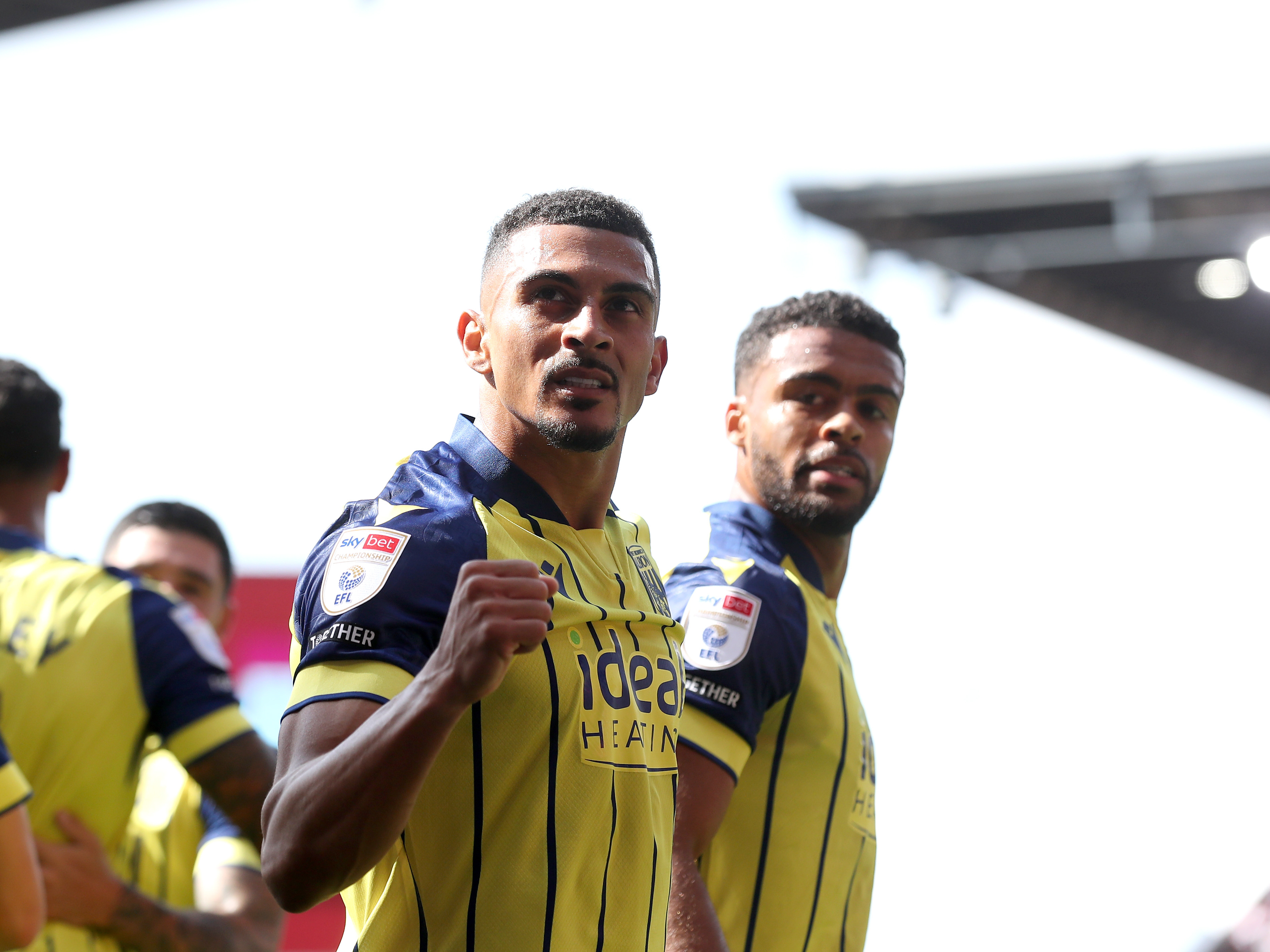 A photo of Albion players in the yellow and blue 2024/25 away kit against Stoke City