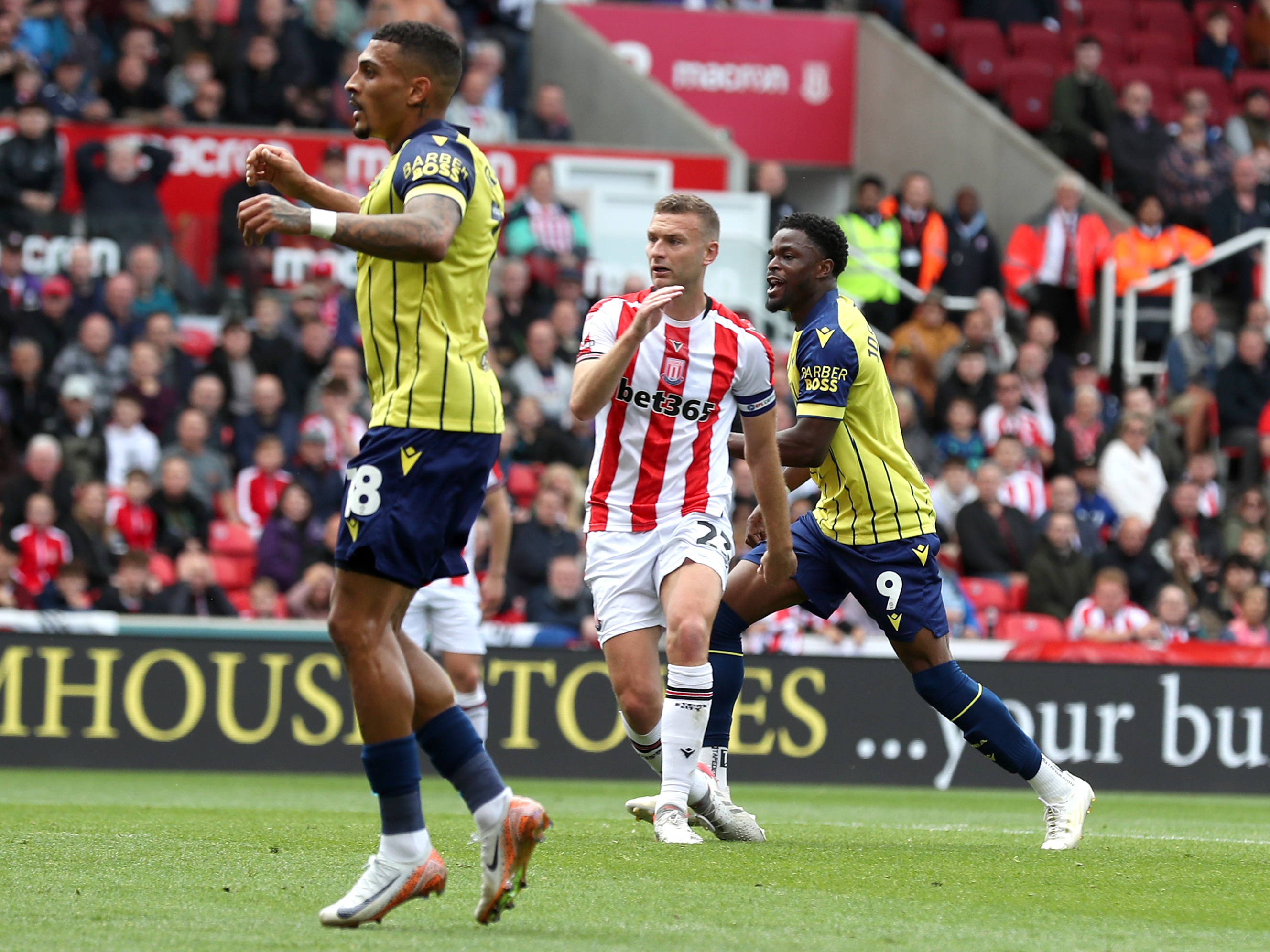 A photo of Albion players in the yellow and blue 2024/25 away kit against Stoke City