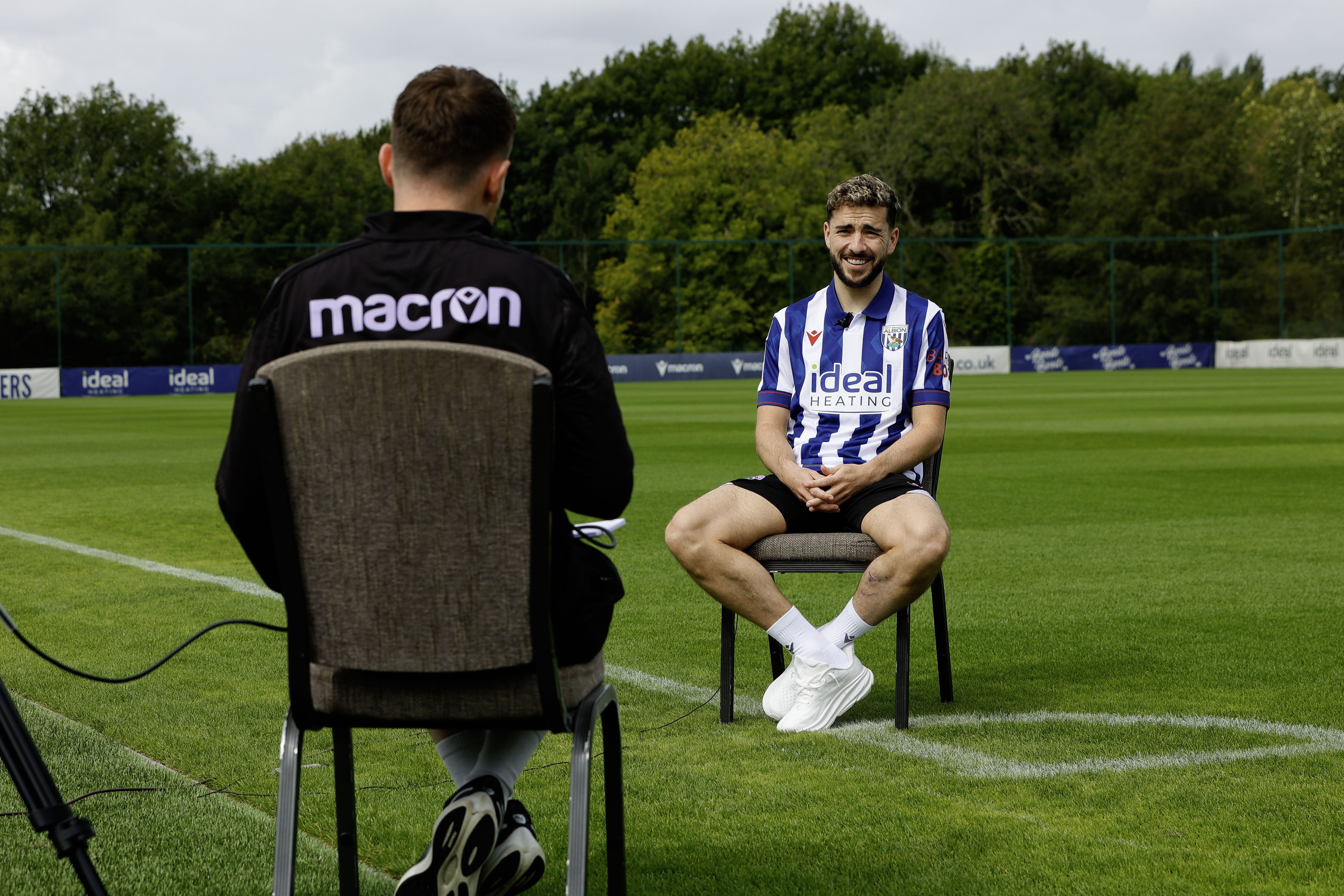 Mikey Johnston sat in a chair on the training pitch being interviewed 