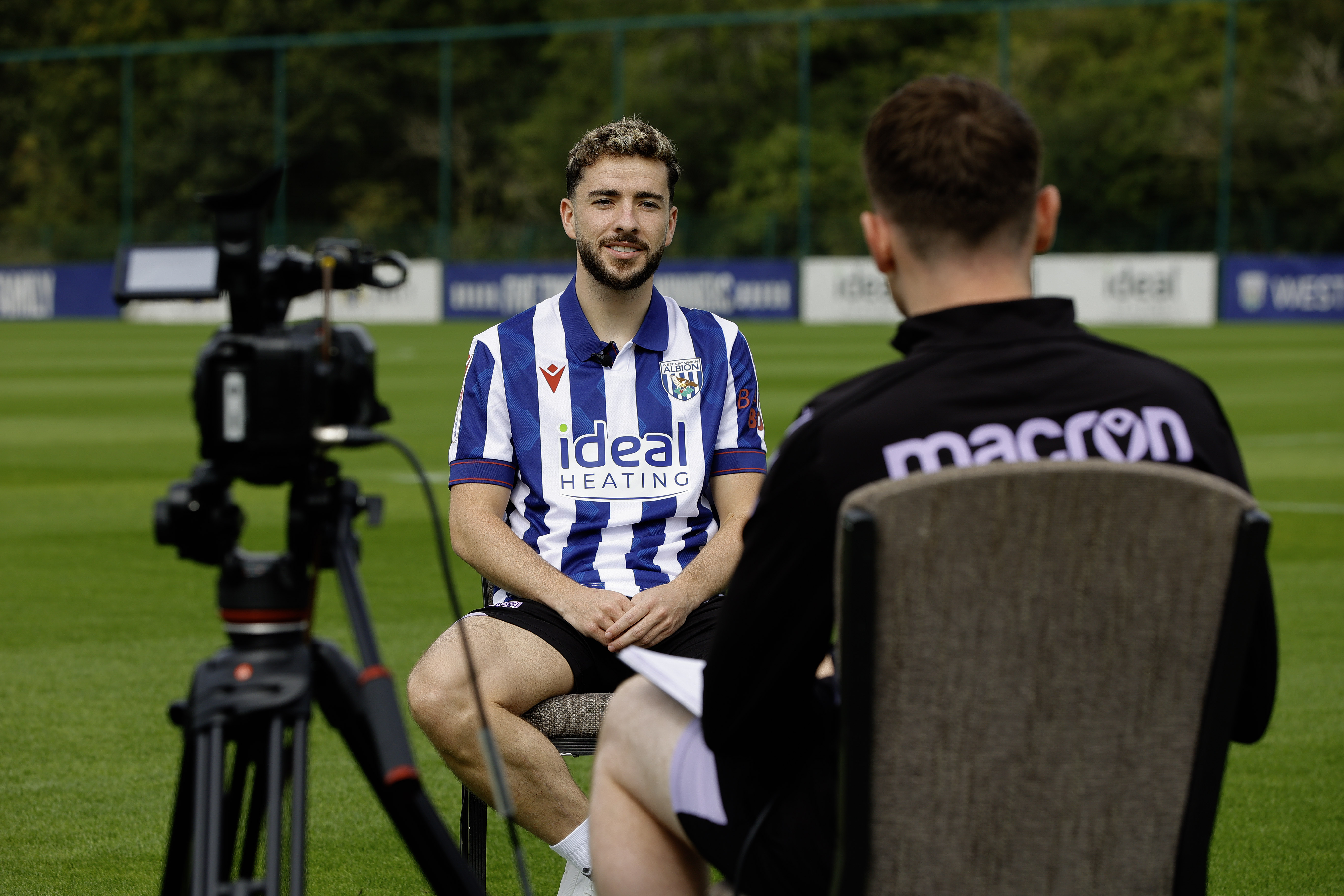 Mikey Johnston sat in a chair on the training pitch being interviewed 