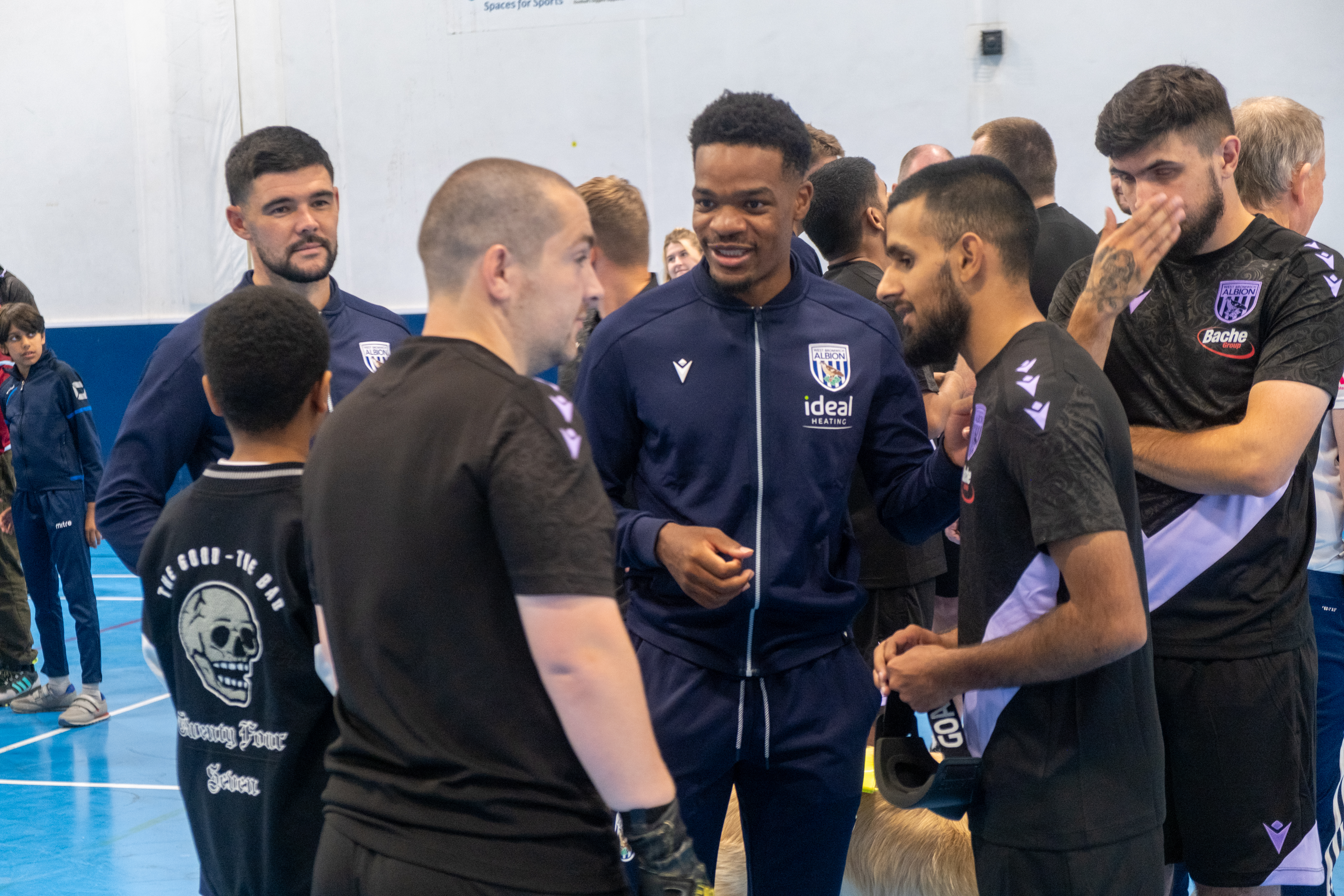 Albion first team players receive a blind football explanation.