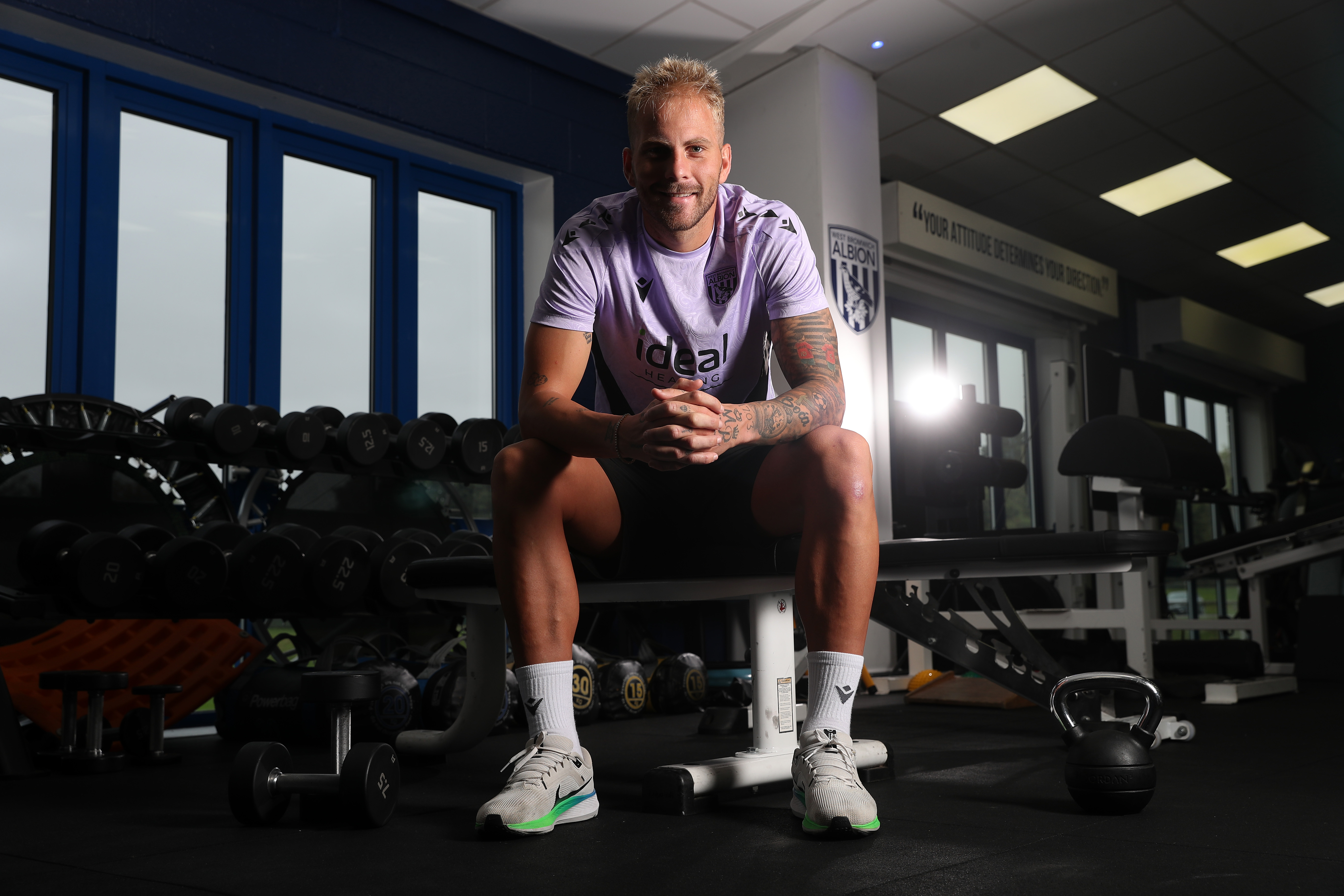 Uroš Račić sat in the gym smiling at the camera 