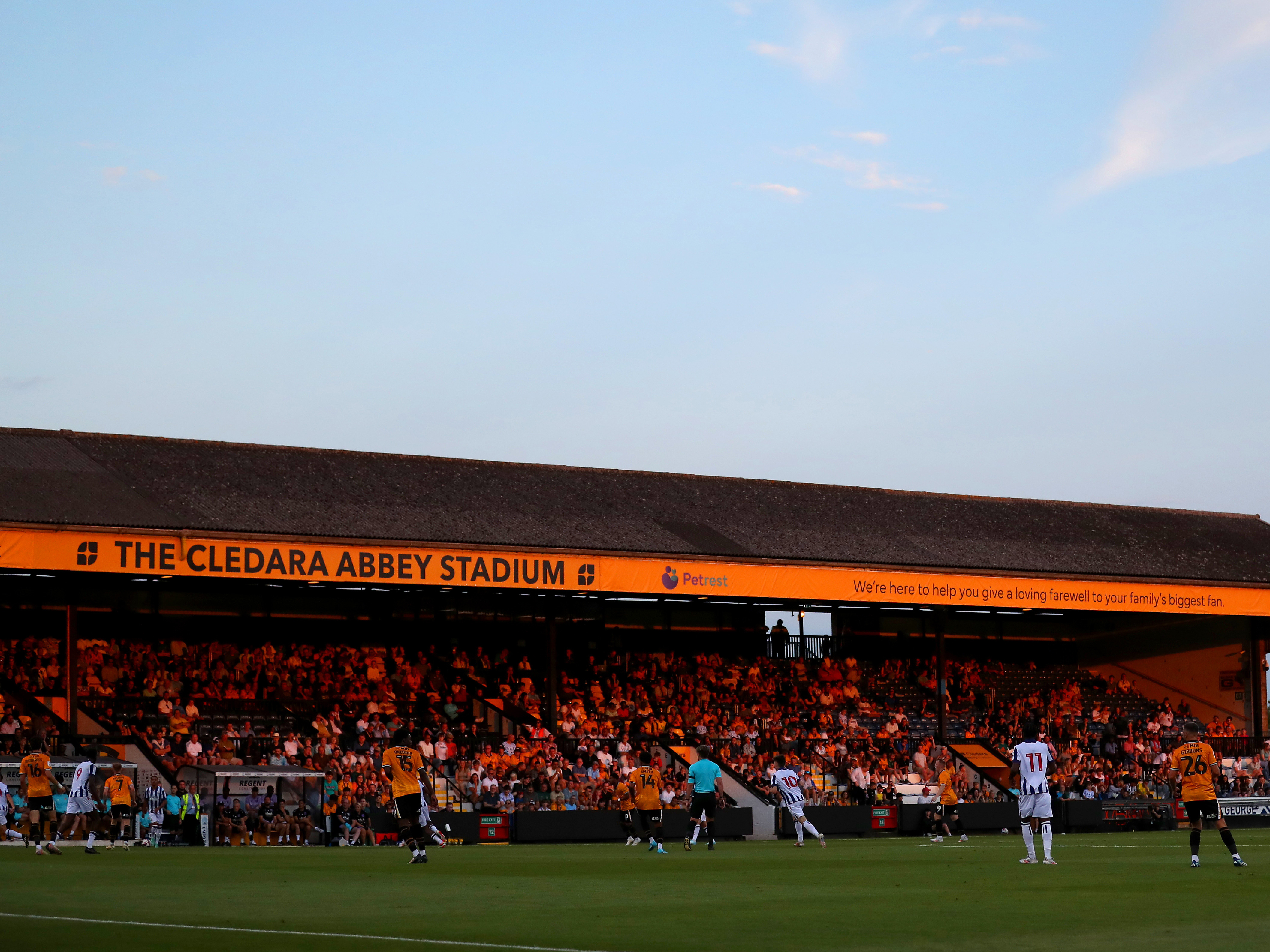 A general shot of action with the main stand at the Cledara Abbey Stadium in the background 