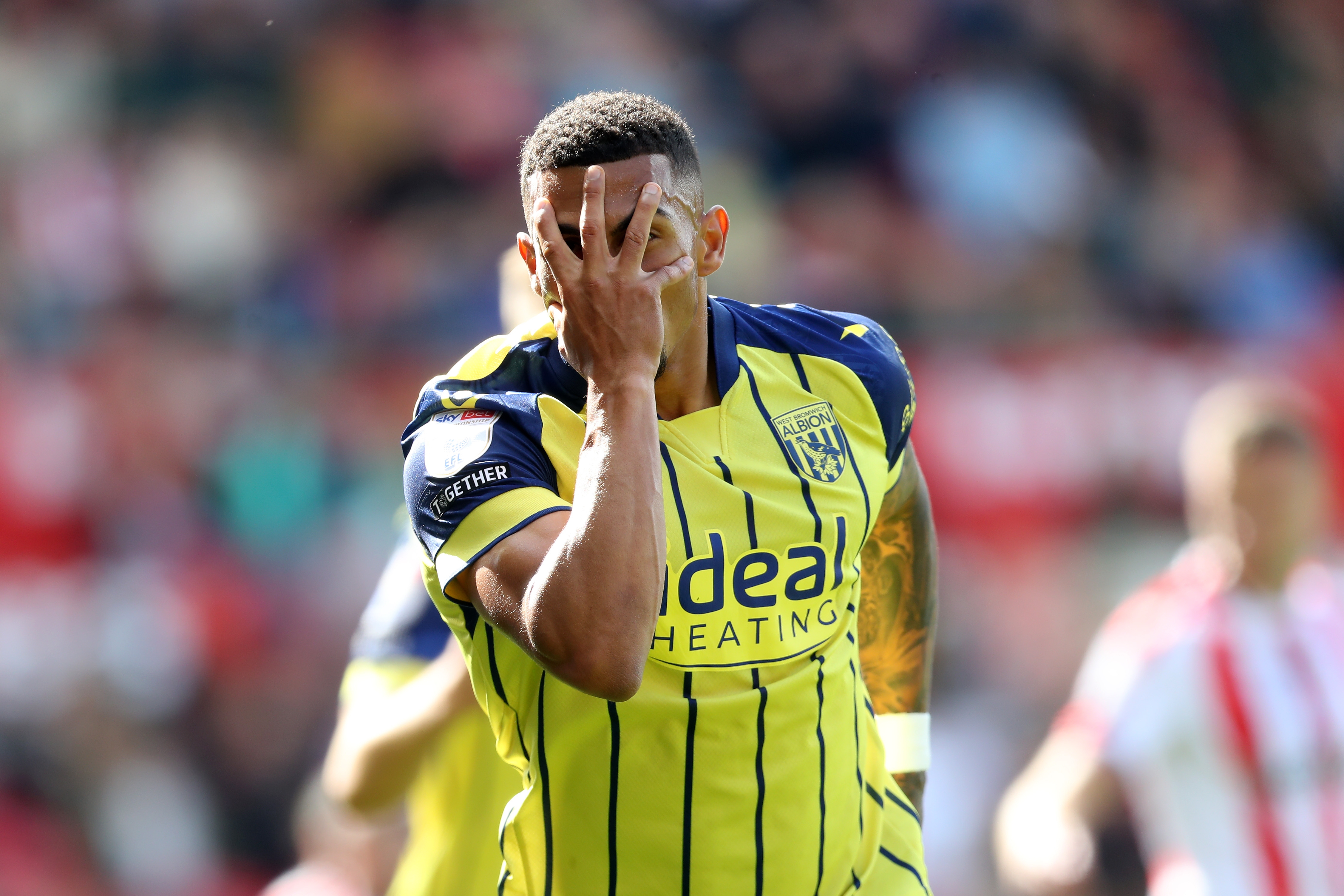 Karlan Grant celebrates after scoring at Stoke in the yellow away kit 