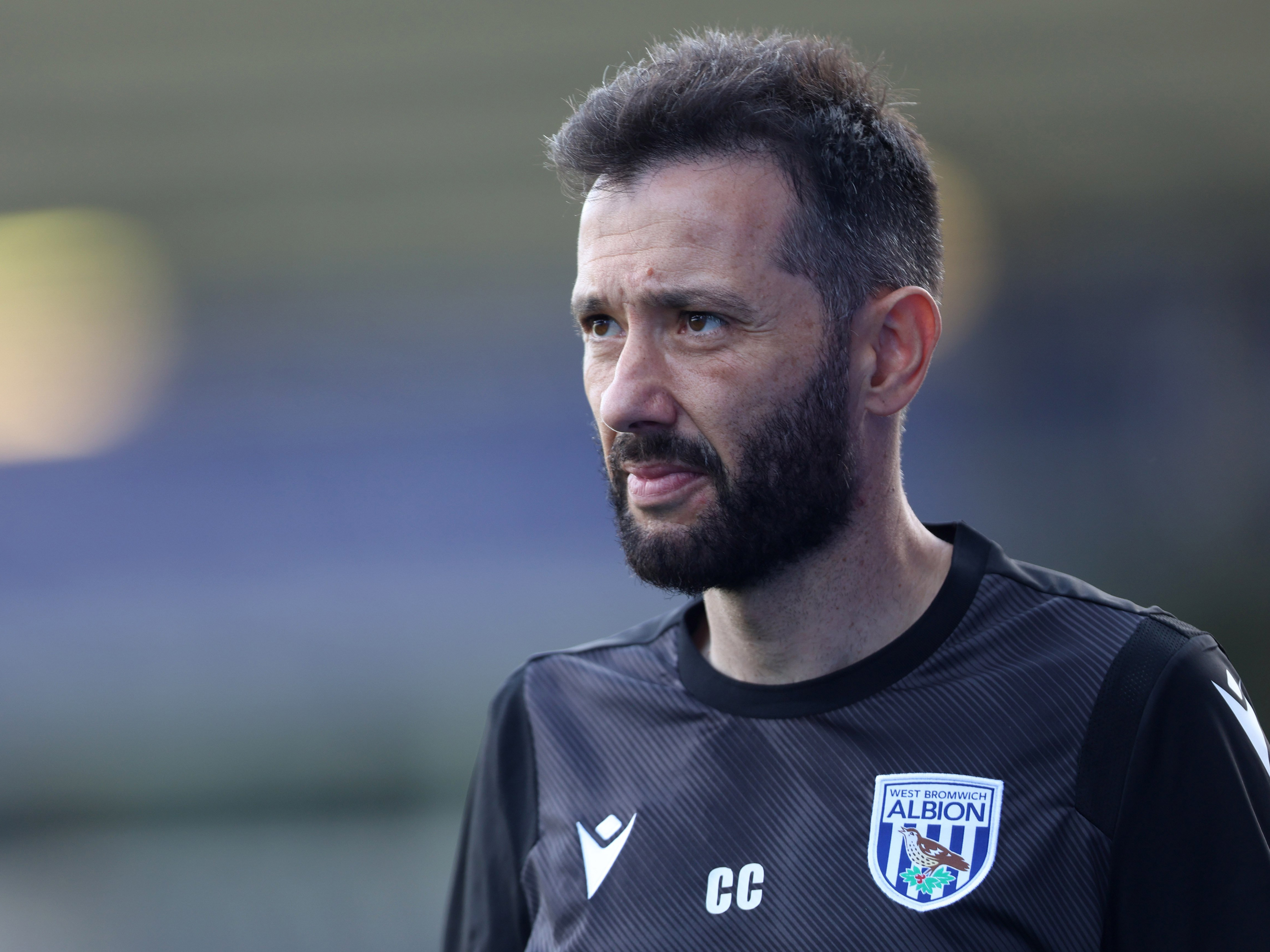 An image of Carlos Corberán in black training gear 