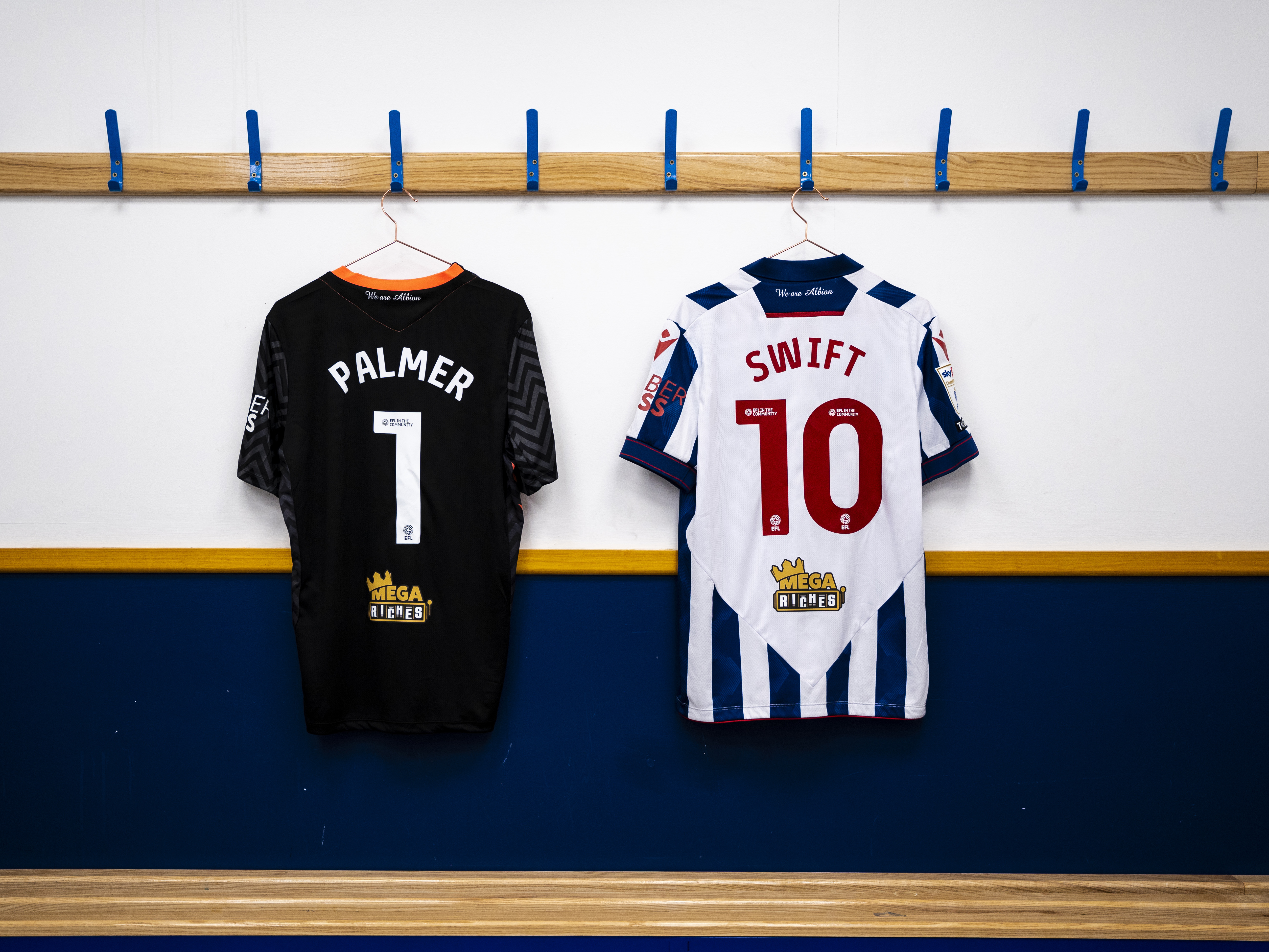 Alex Palmer's No.1 shirt and John Swift's No.10 shirt hanging up in a dressing room