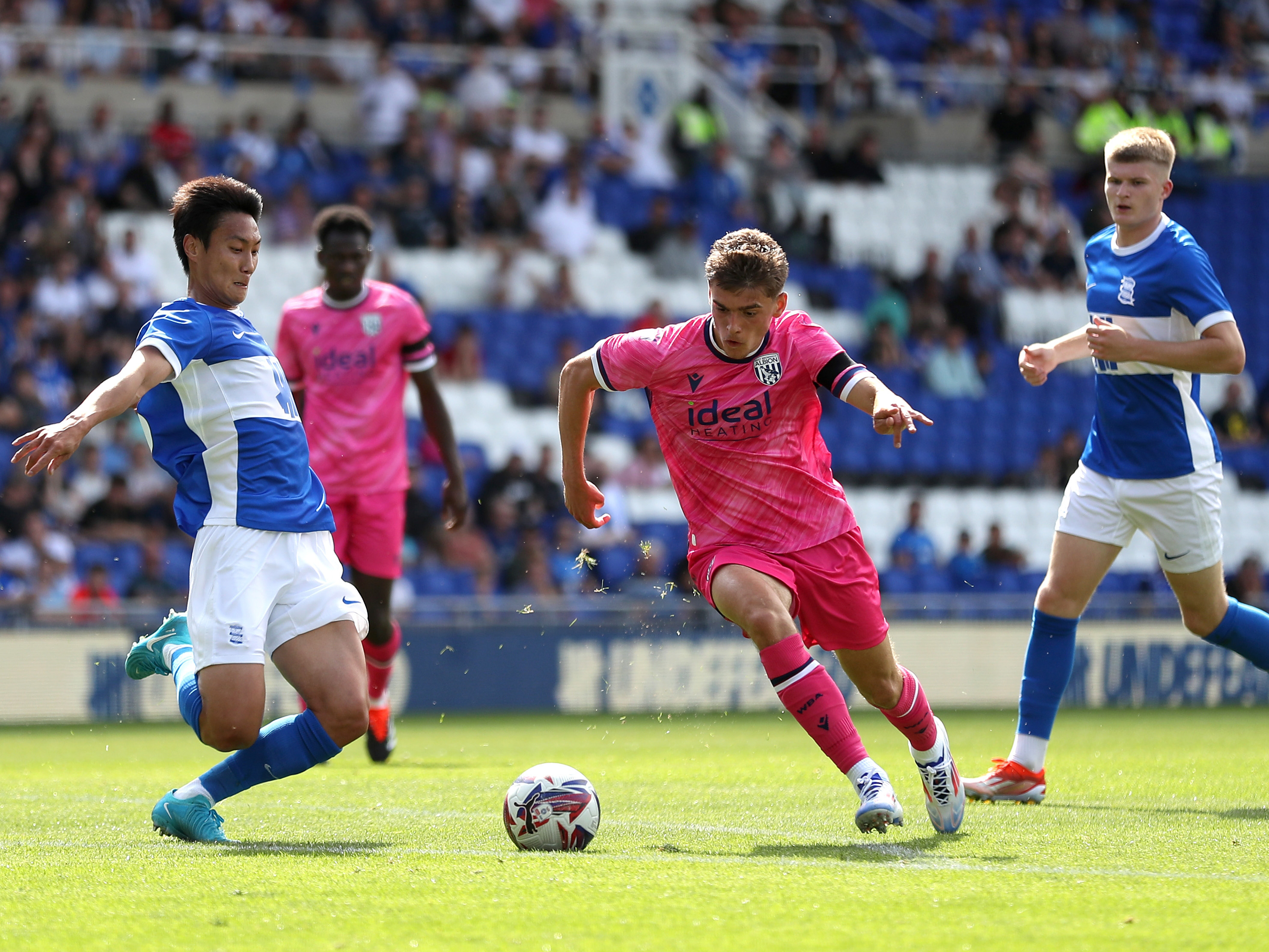 An image of Tom Fellows running with the ball against Birmingham City