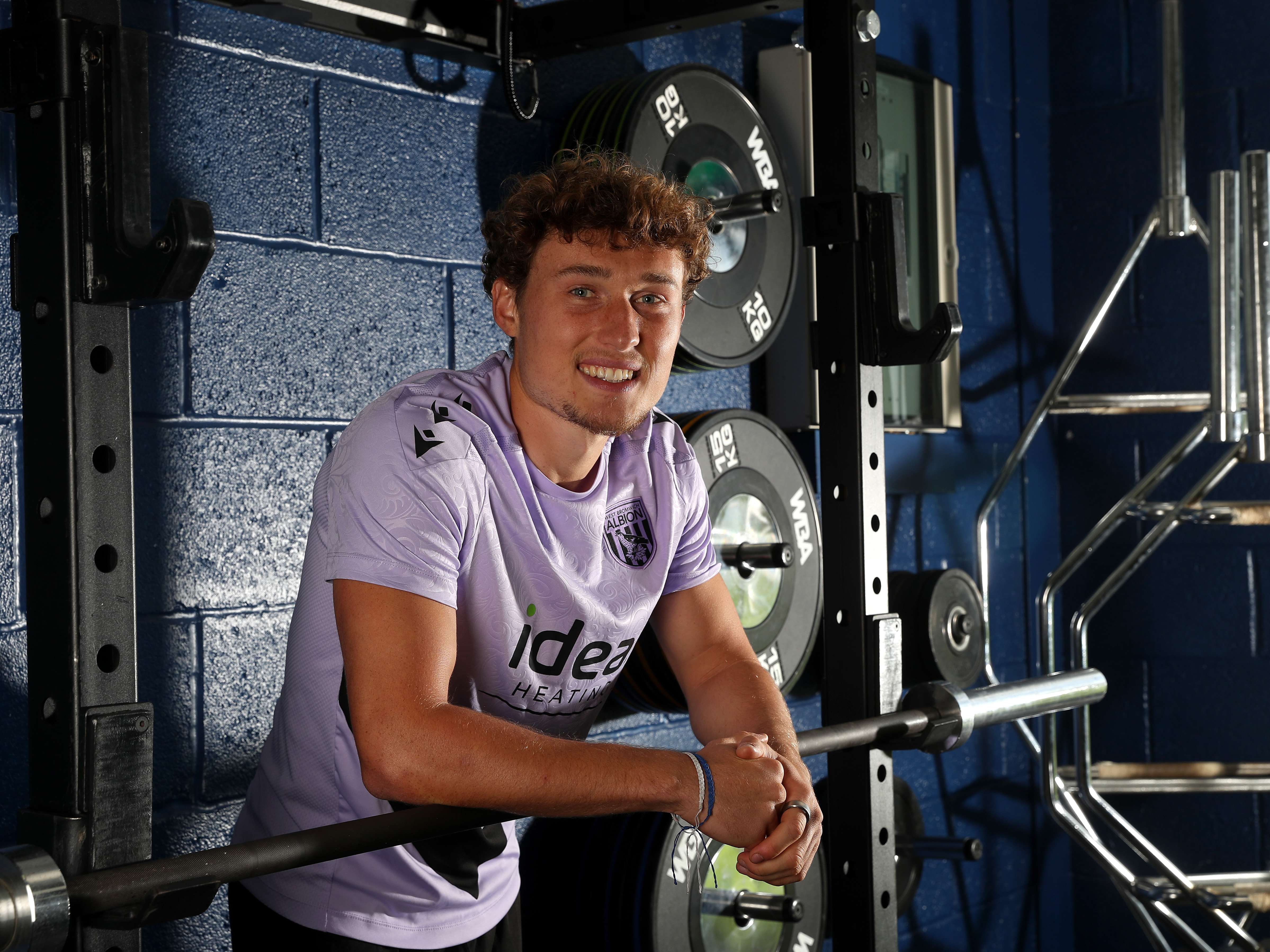 Callum Styles smiling at the camera while stood in the gym