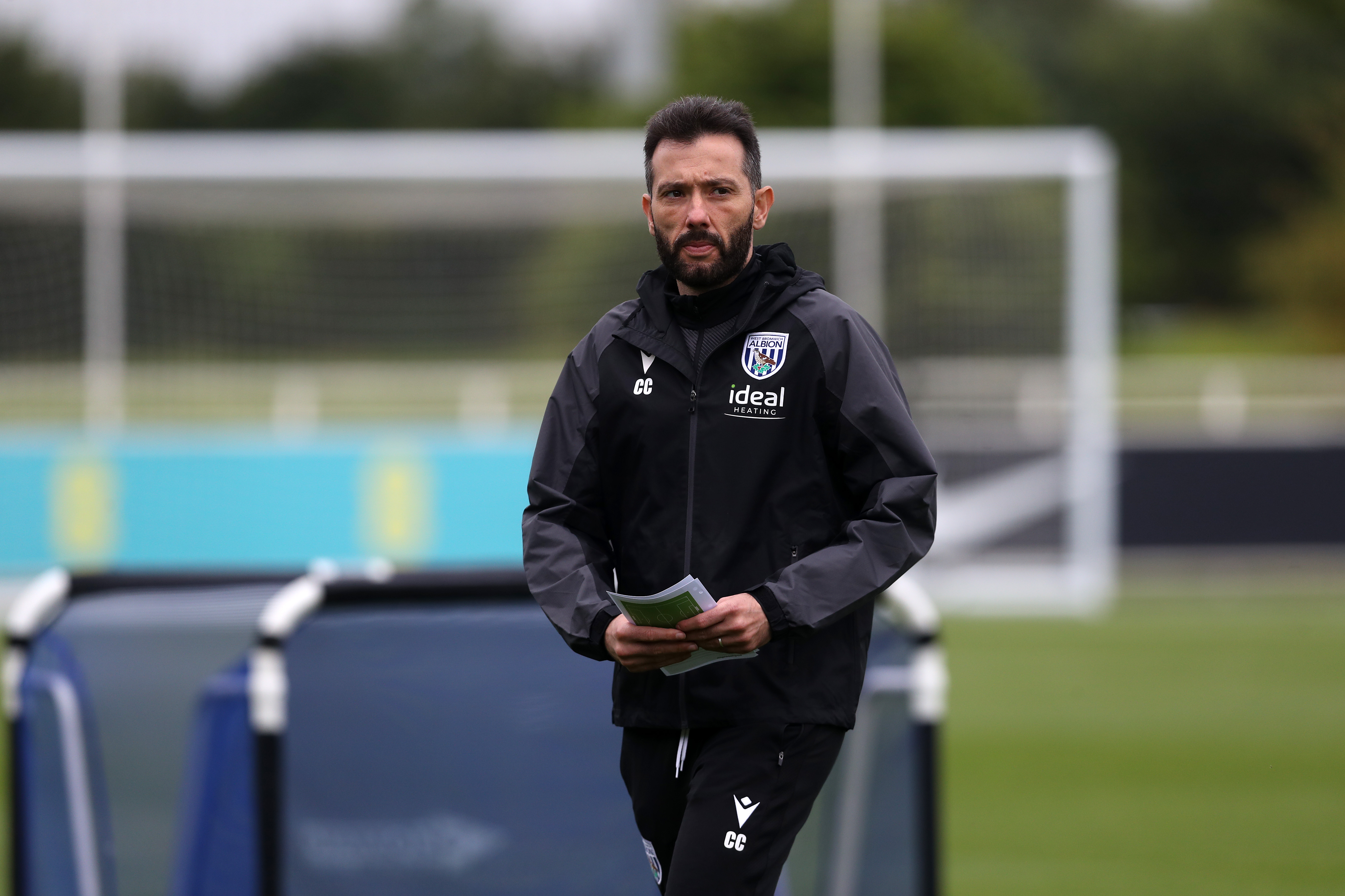 Carlos Corberán holding a notepad during a training session 