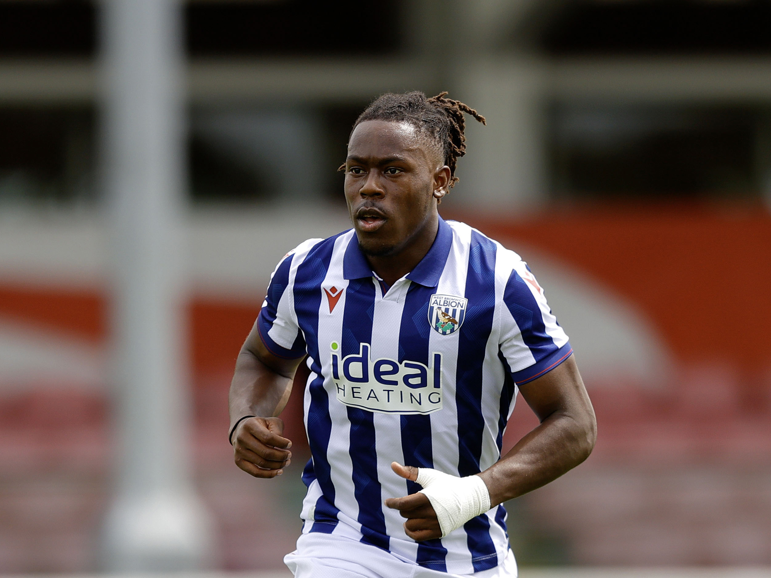 Brandon Thomas-Asante in action for Albion wearing the home shirt 