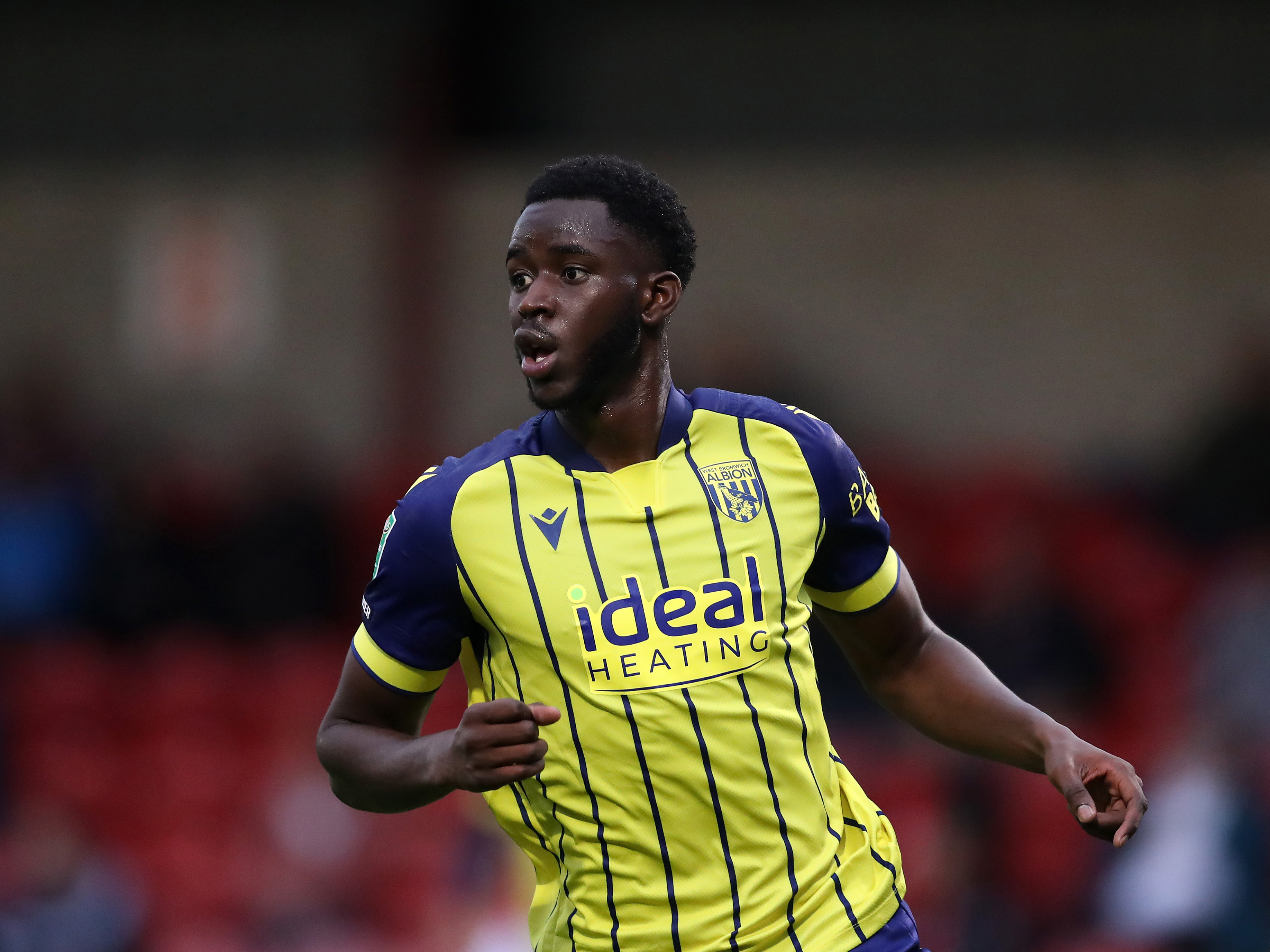 Mo Faal in action for Albion in the yellow away kit 