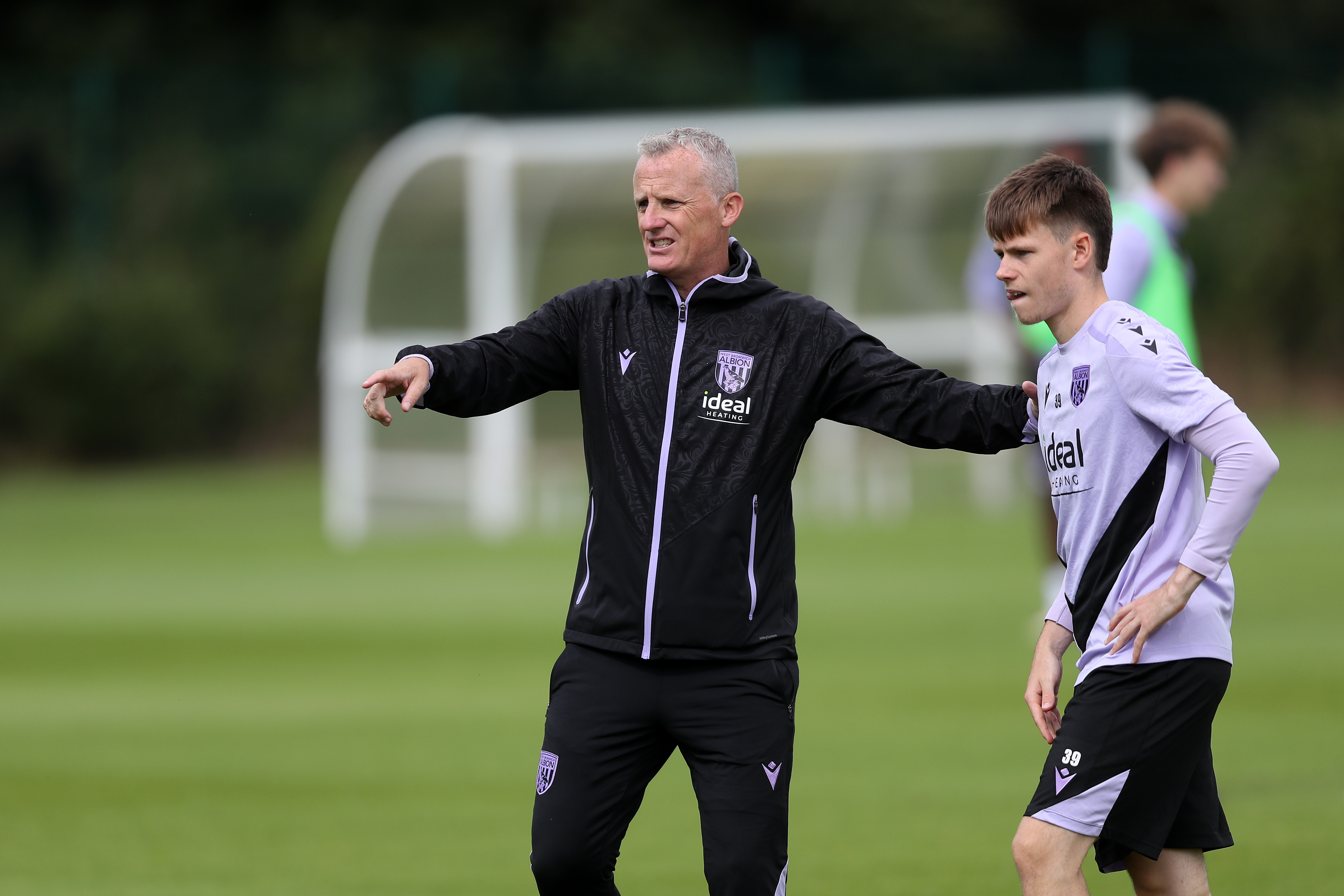 Richard Beale delivering instructions to Fenton Heard on the training pitch 