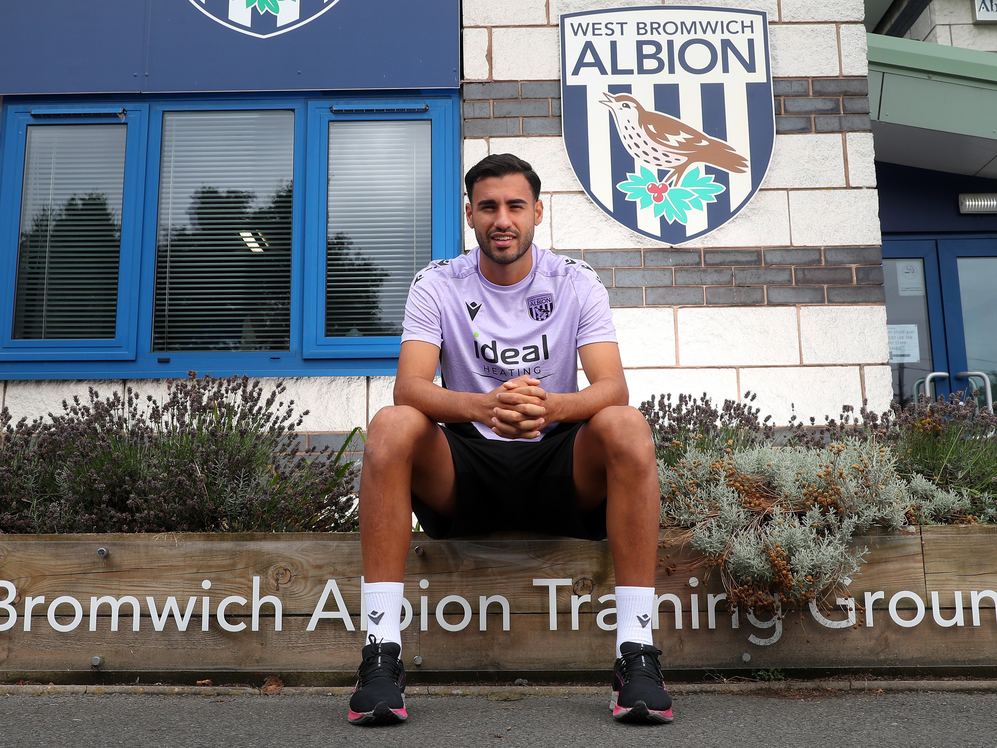 Gianluca Frabotta sat smiling at the camera outside the training ground 