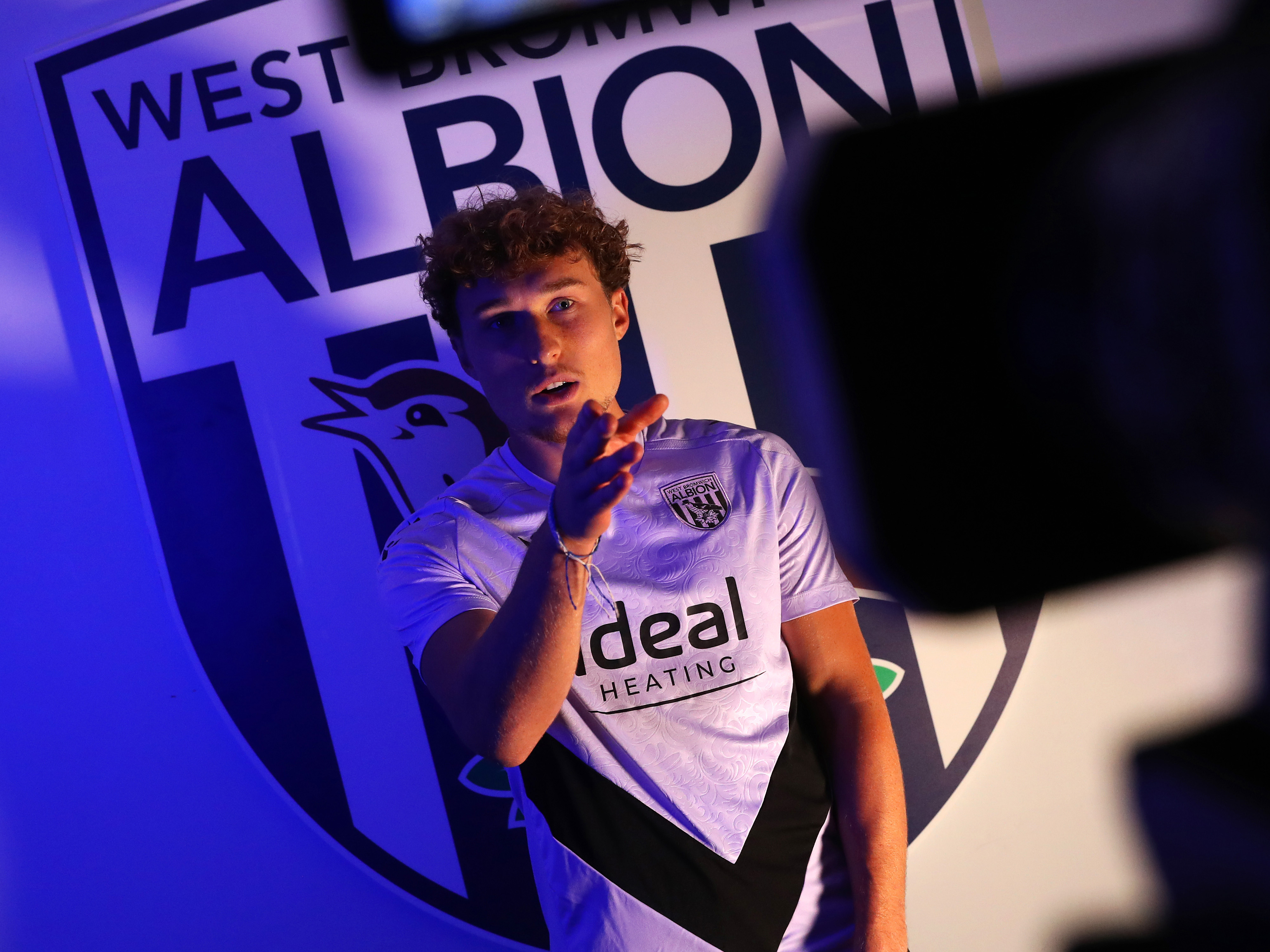 Callum Styles being interviewed in front of a WBA badge 