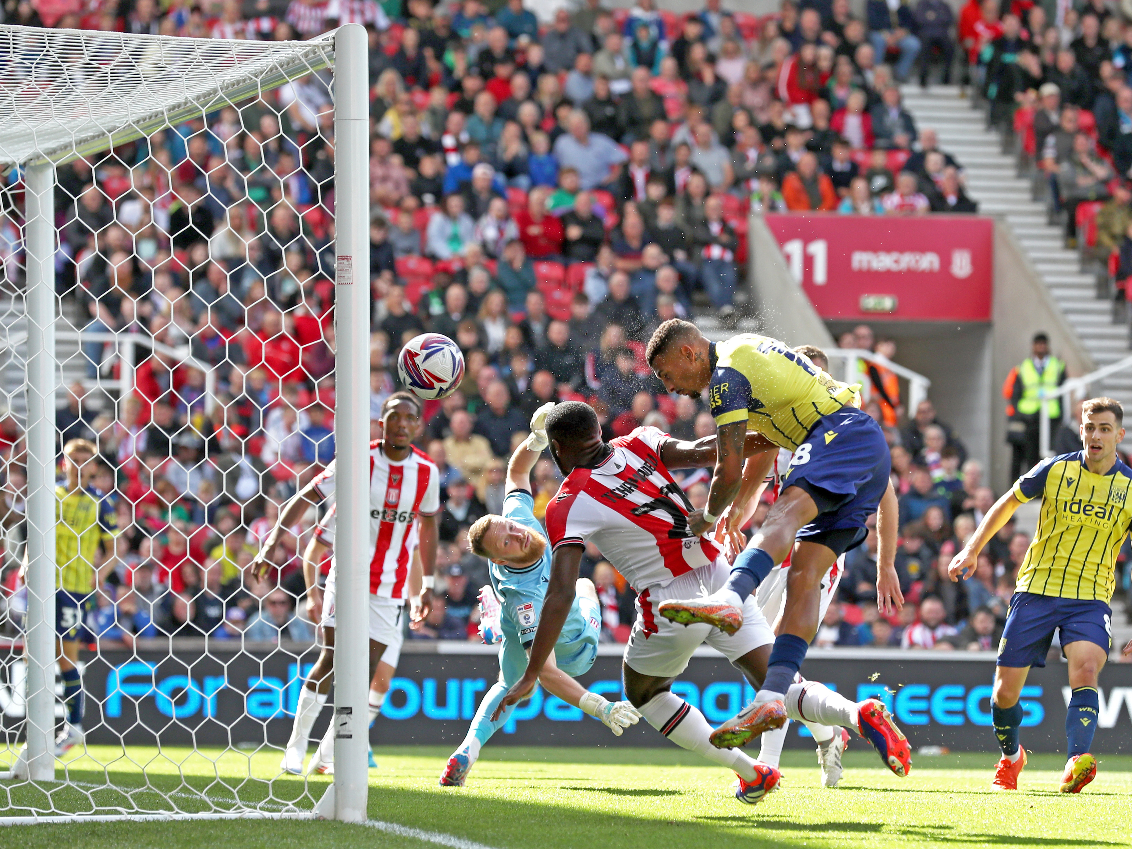 An image of Karlan Grant scoring against Stoke with a header