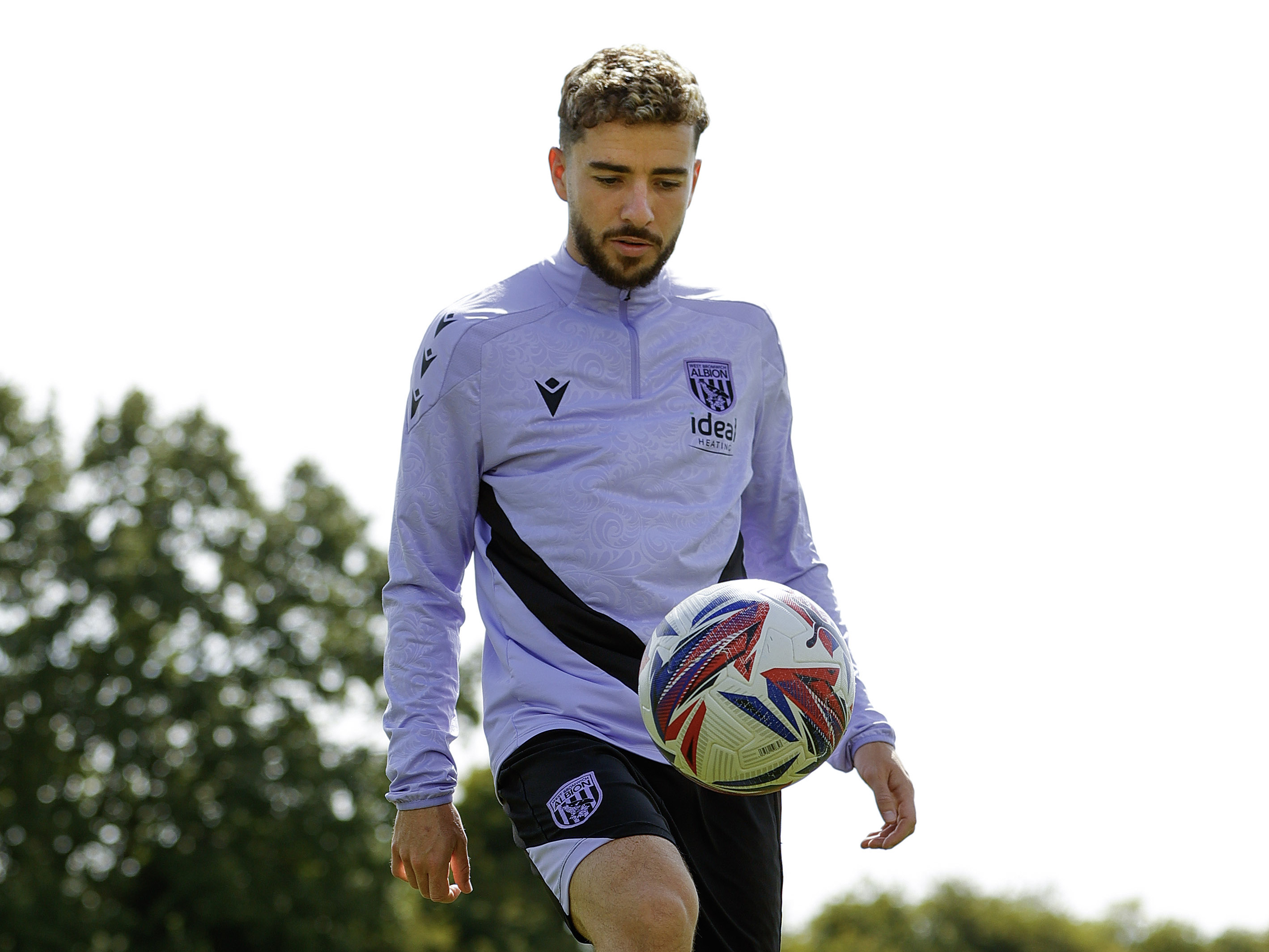 Mikey Johnston juggling a ball in training kit 